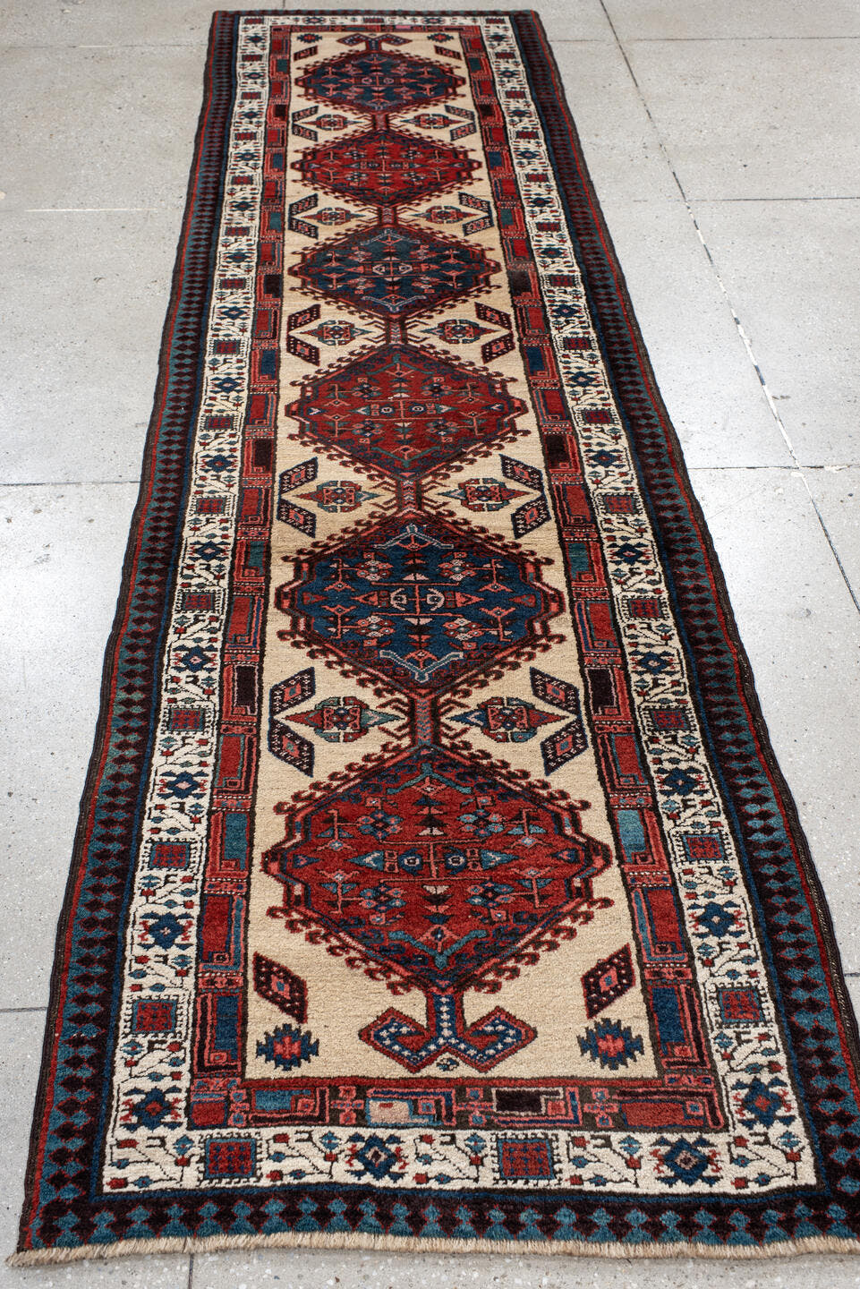 3' x 11' one-of-a-kind handmade antique Sarab runner rug. Color palette: ivory, rust, indigo, navy, crimson, charcoal