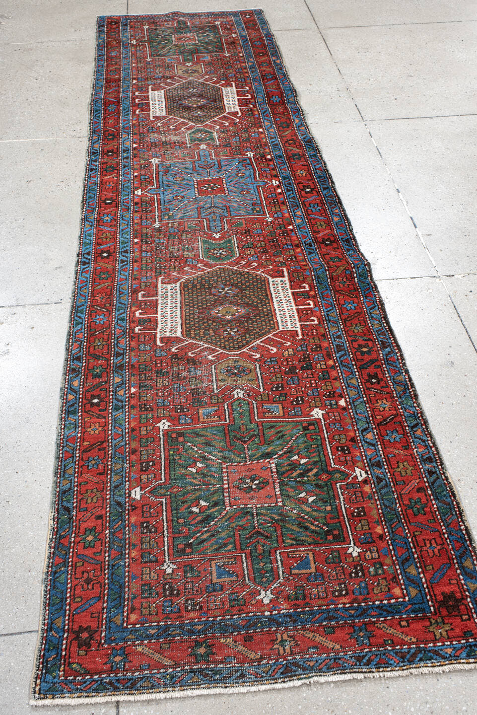 2' x 10' one-of-a-kind handmade antique Karaje runner rug. Color palette: rust, sky blue, ivory, teal, crimson, charcoal