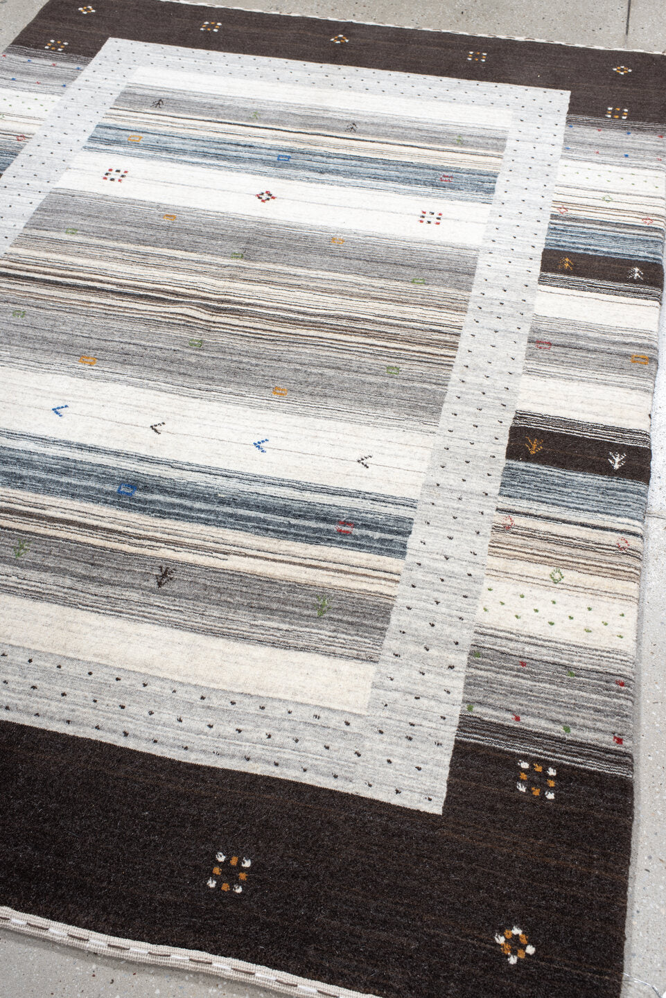 5' x 7' one-of-a-kind handmade vintage Gabbe rug. Color palette: black, blue, brown, charcoal, dark gray, dim gray