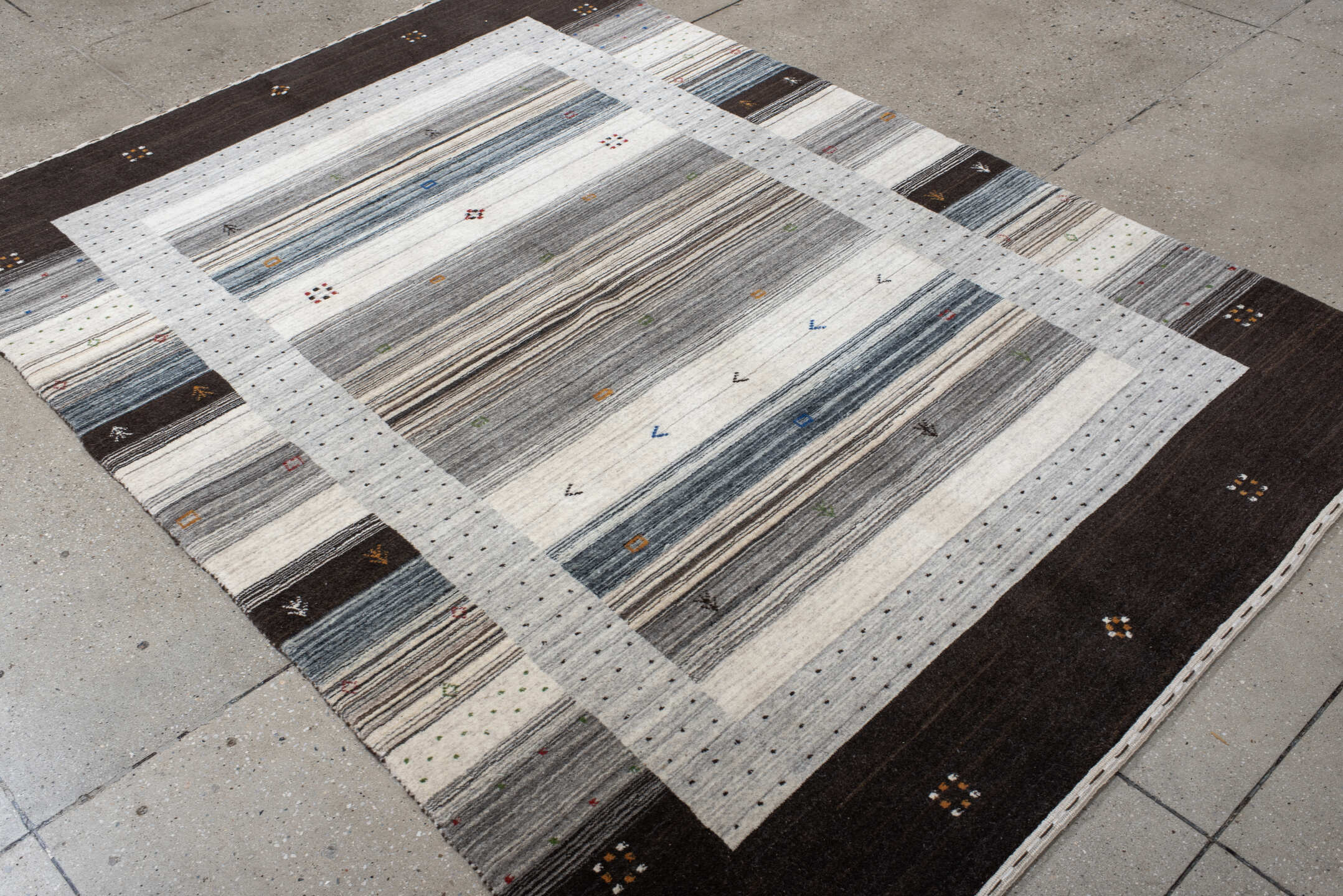5' x 7' one-of-a-kind handmade vintage Gabbe rug. Color palette: black, blue, brown, charcoal, dark gray, dim gray