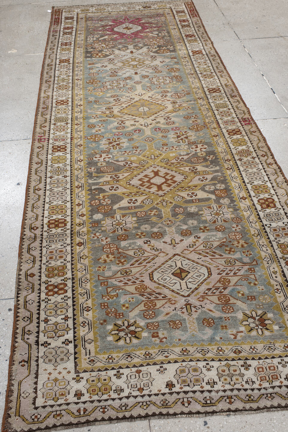 3' x 10' one-of-a-kind handmade antique Caucasian runner rug. Color palette: ivory, pale blue, taupe, rose, rust, gold, sage