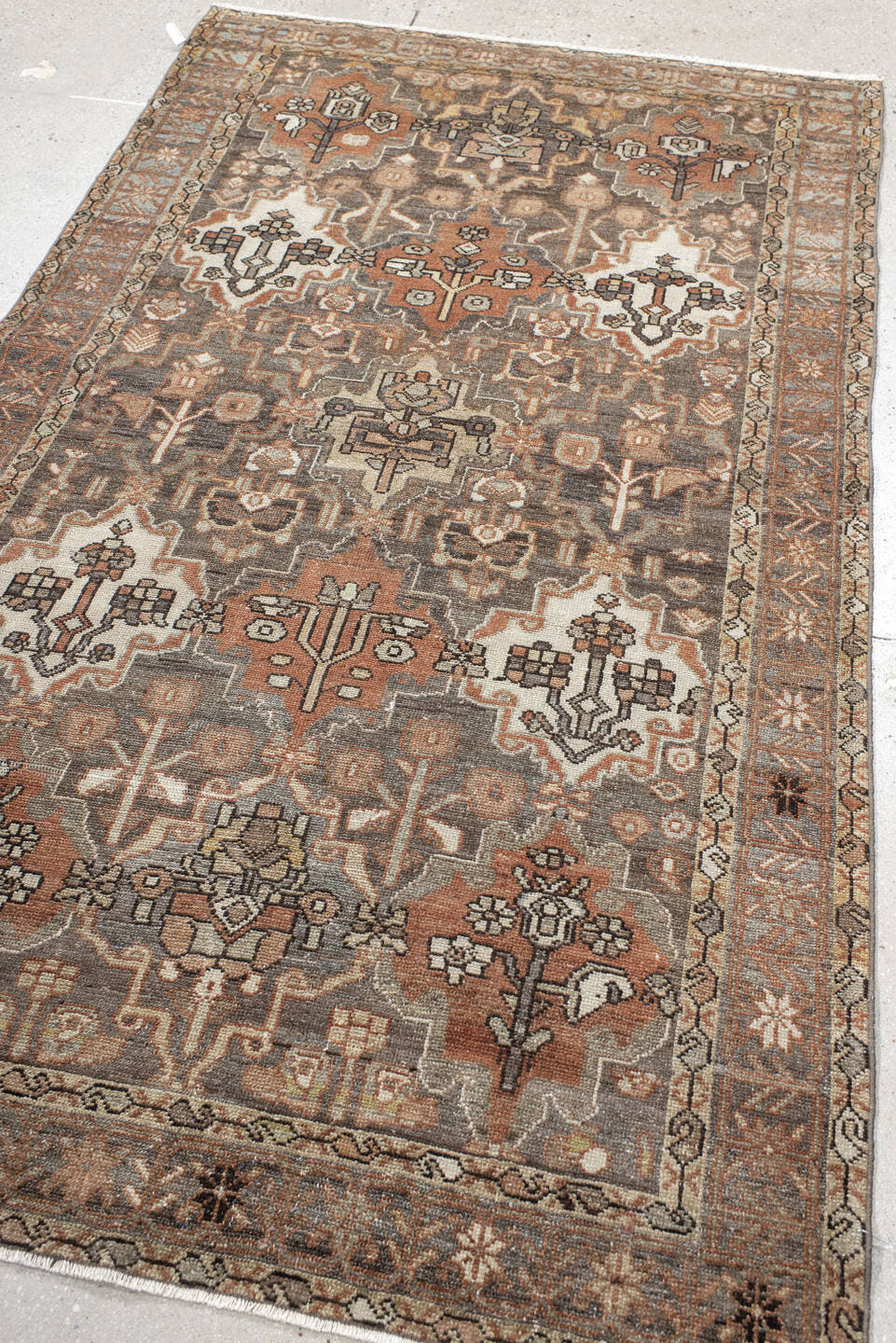 4' x 7' one-of-a-kind handmade vintage Baktiary rug. Color palette: taupe, terra cotta, ivory, slate, camel, charcoal, rose