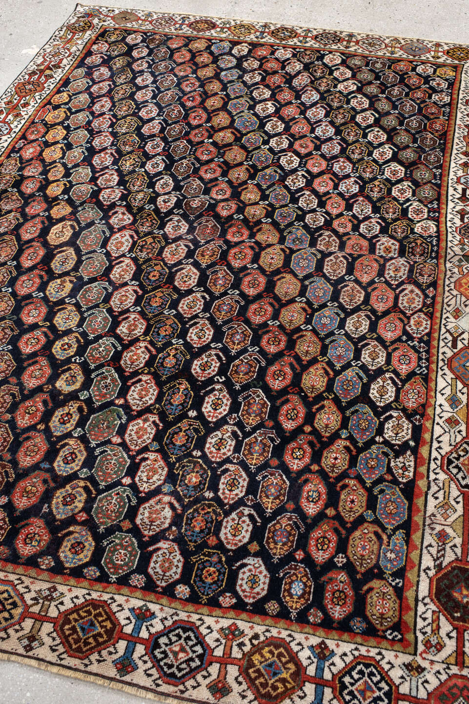5' x 7' one-of-a-kind handmade vintage Qashqai rug. Color palette: ivory, charcoal, rust, crimson, indigo, camel, slate