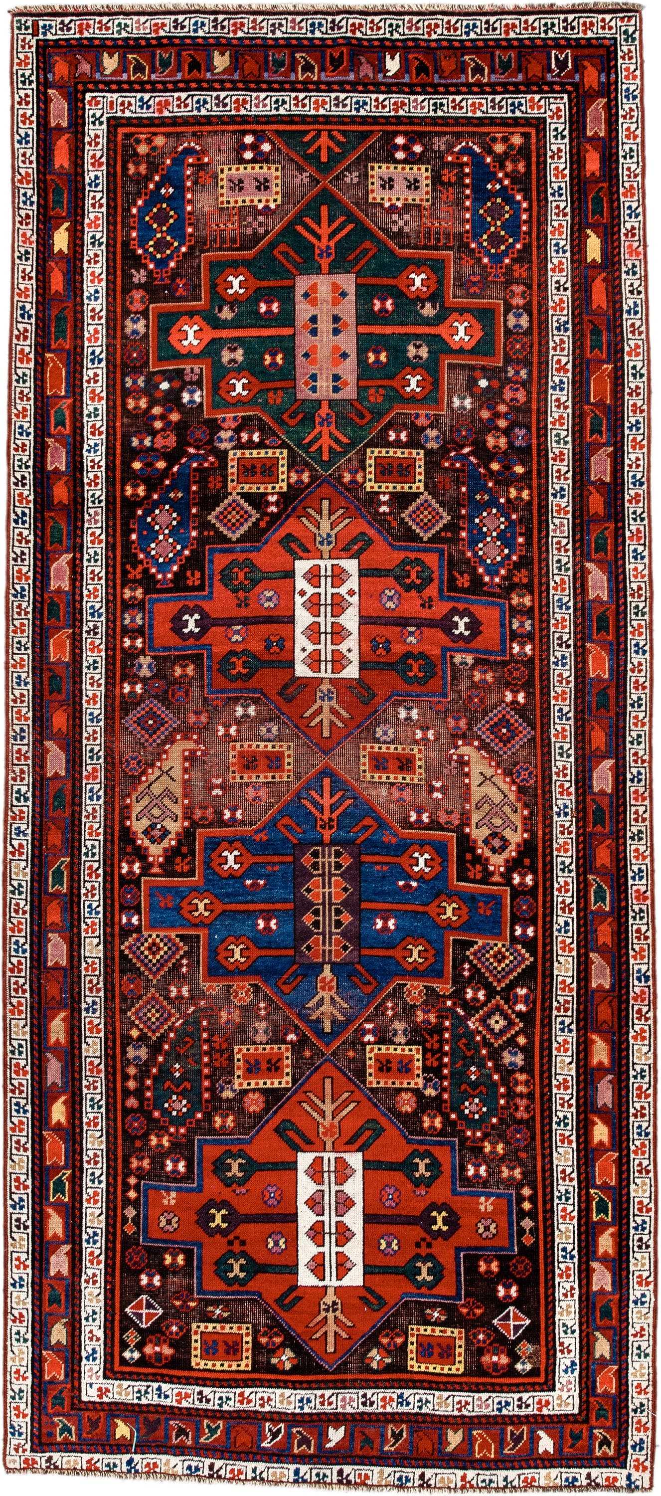 3' x 8' one-of-a-kind handmade antique Caucasian runner rug. Color palette: rust, ivory, navy, indigo, camel, crimson