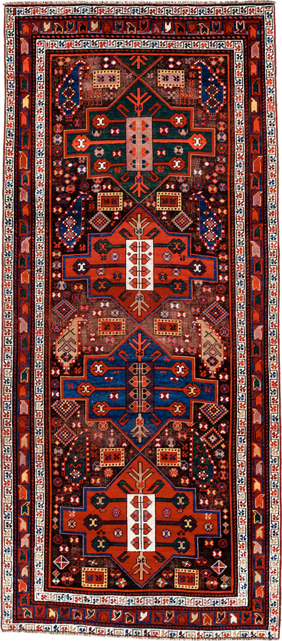 3' x 8' one-of-a-kind handmade antique Caucasian runner rug. Color palette: rust, ivory, navy, indigo, camel, crimson