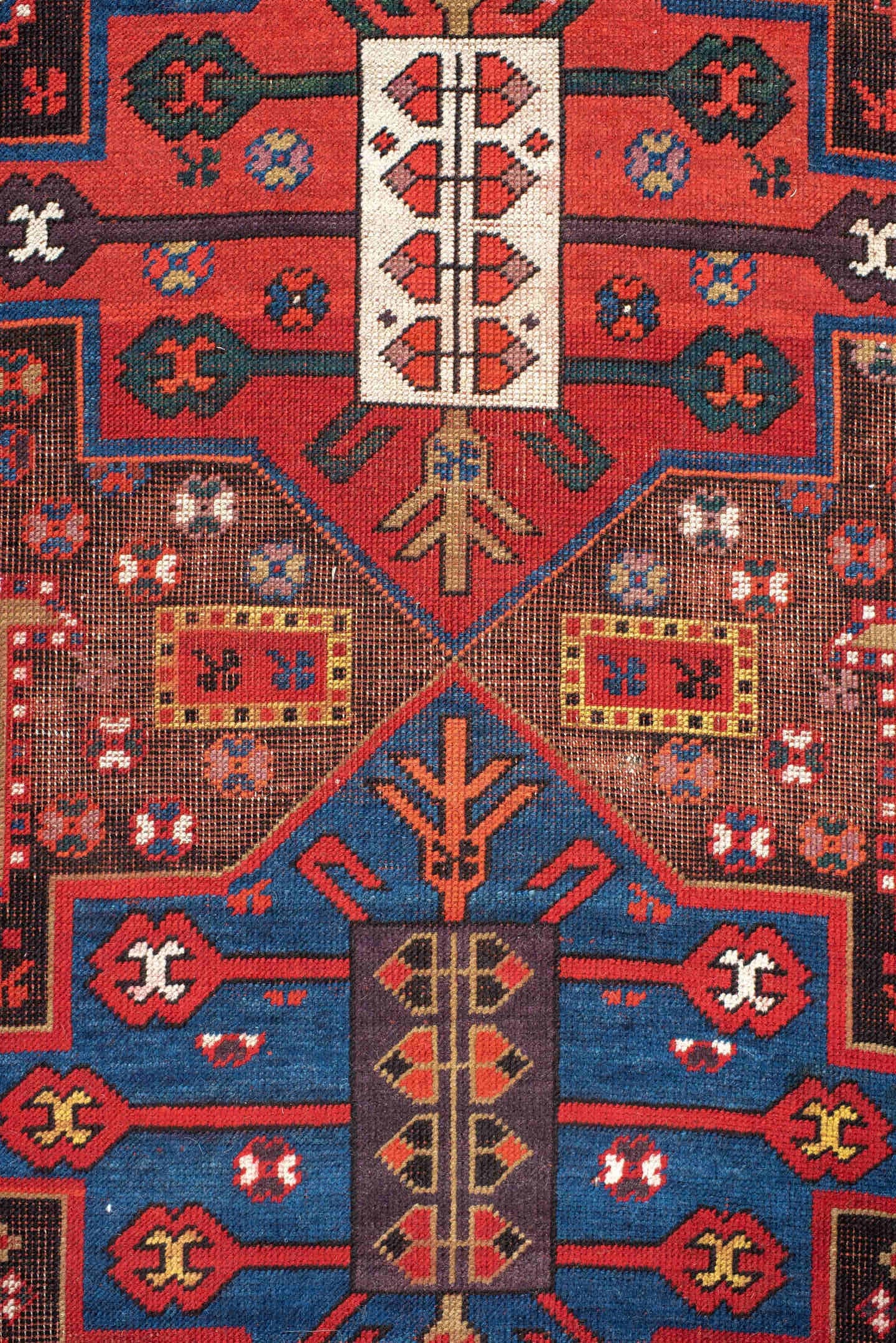 3' x 8' one-of-a-kind handmade antique Caucasian runner rug. Color palette: rust, ivory, navy, indigo, camel, crimson