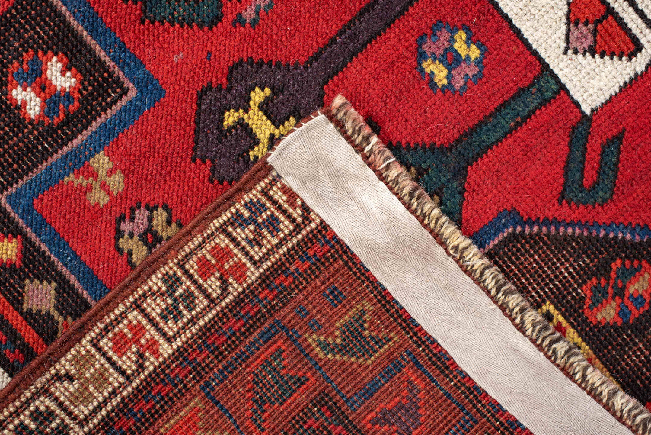 3' x 8' one-of-a-kind handmade antique Caucasian runner rug. Color palette: rust, ivory, navy, indigo, camel, crimson