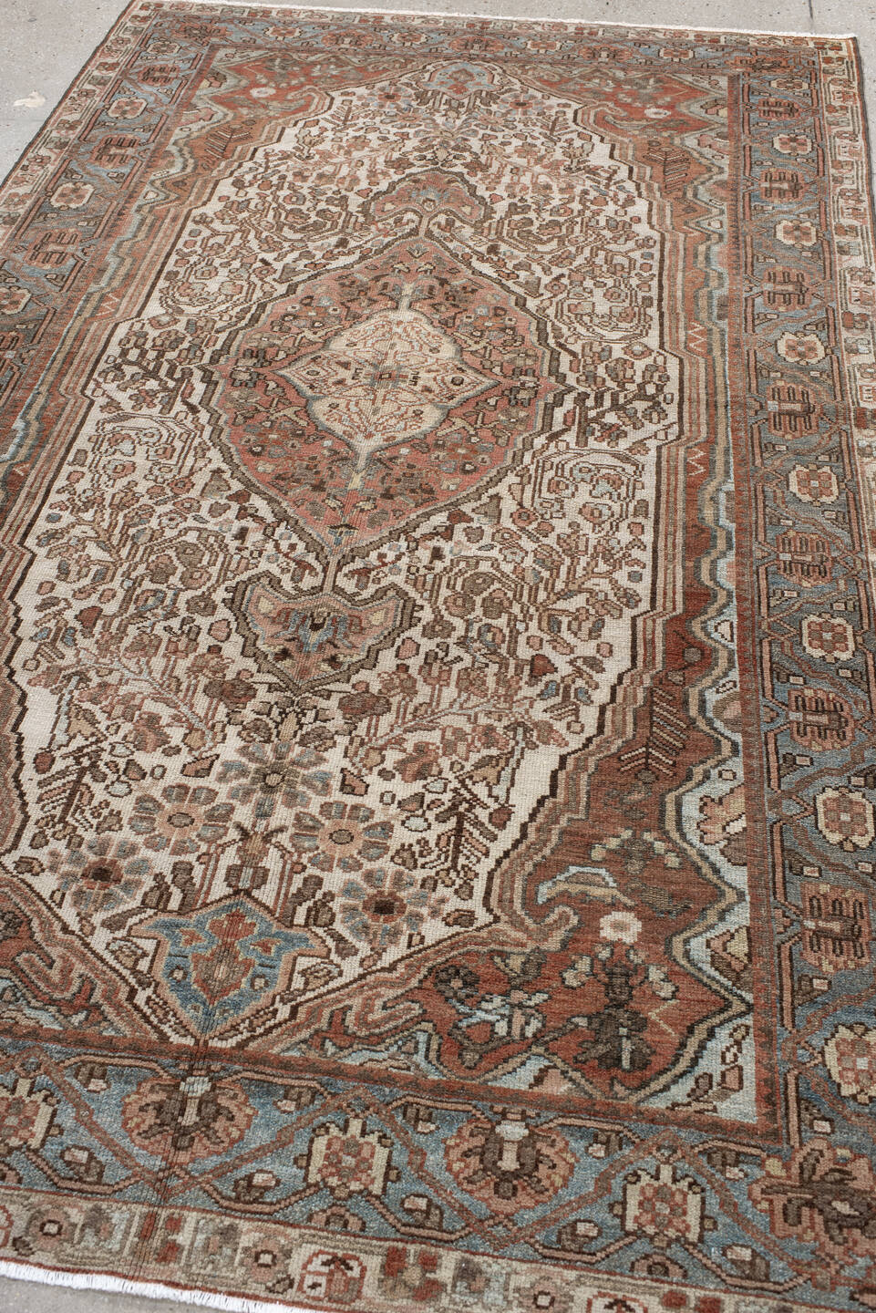 5' x 8' one-of-a-kind handmade antique Baktiary medium size rug. Color palette: ivory, dusty blue, rust, taupe, brown