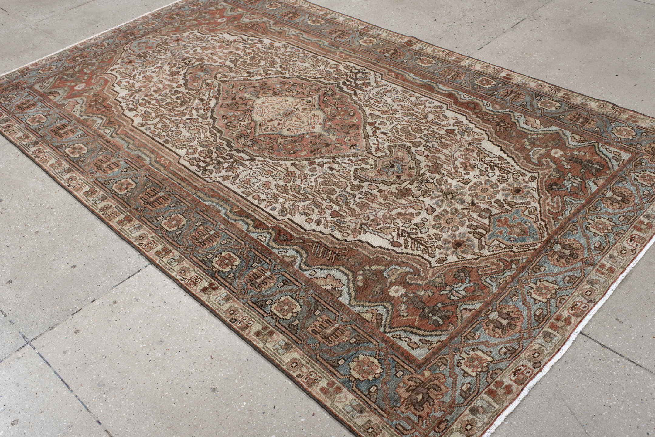 5' x 8' one-of-a-kind handmade antique Baktiary medium size rug. Color palette: ivory, dusty blue, rust, taupe, brown