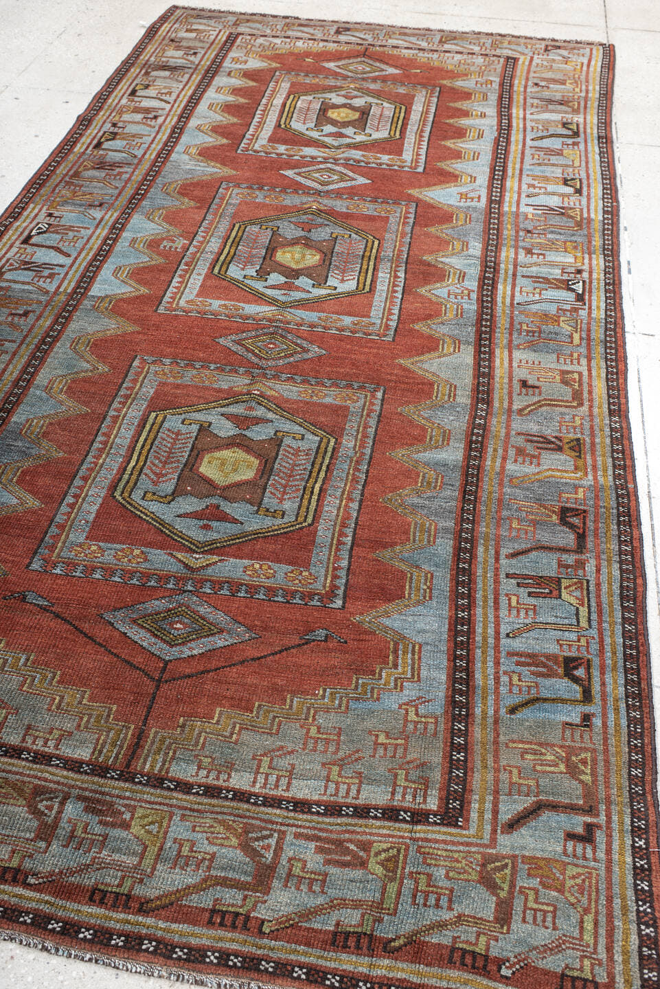 5' x 10' one-of-a-kind handmade antique NW Persian medium size rug. Color palette: rust, ivory, sky blue, camel, charcoal