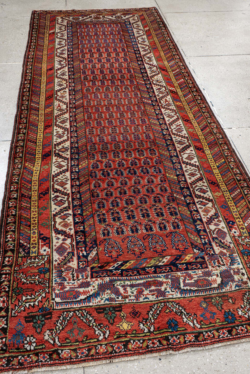 4' x 11' one-of-a-kind handmade antique NW Persian runner rug. Color palette: rust, ivory, indigo, navy, terra cotta, camel