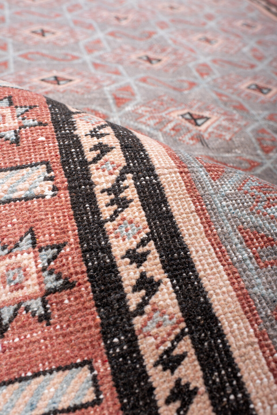 4' x 7' one-of-a-kind handmade vintage Sparta rug. Color palette: black, brown, gray, light gray, off-white, pink, red