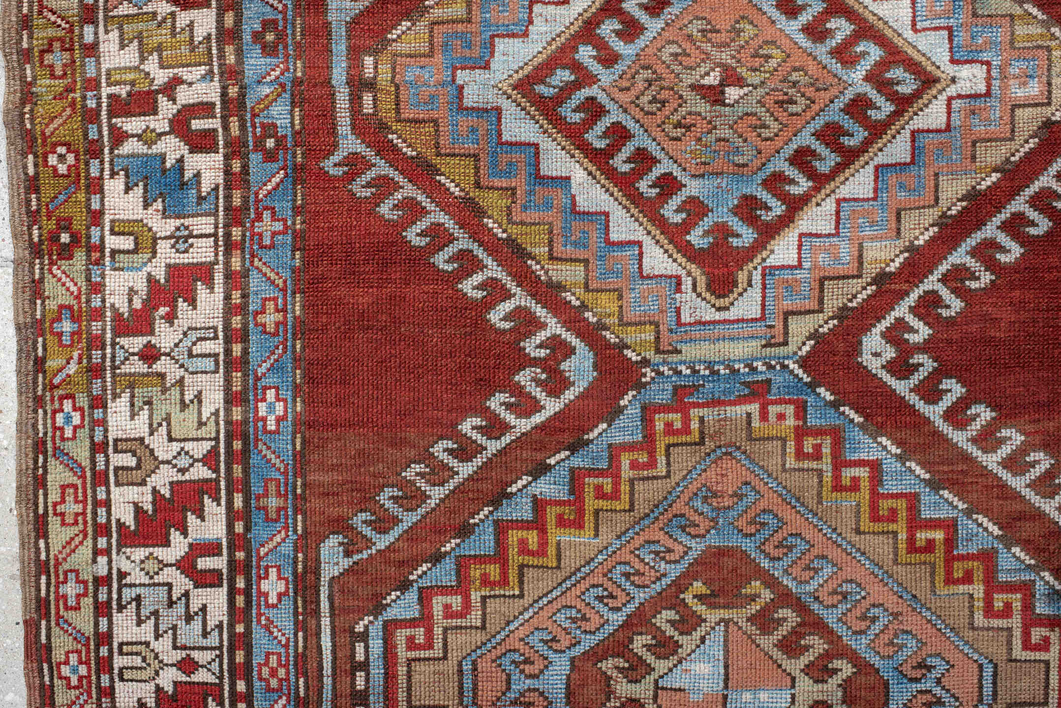 4' x 7' one-of-a-kind handmade vintage Kazak rug. Color palette: rust, ivory, sky blue, brick red, camel, taupe, gold, brown