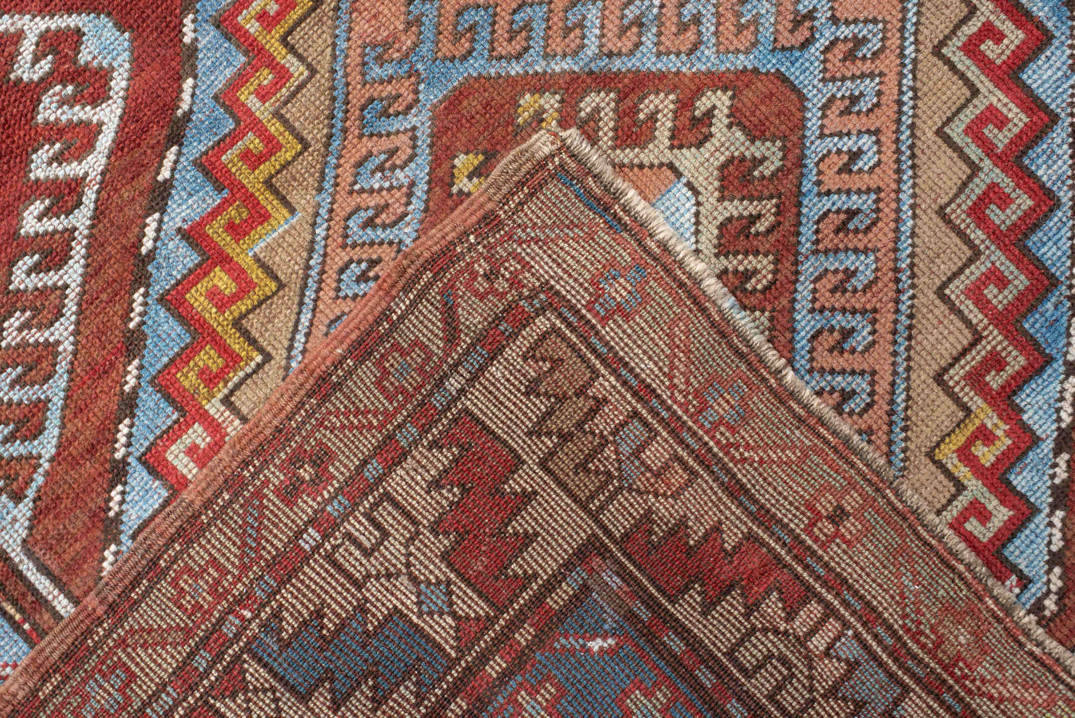 4' x 7' one-of-a-kind handmade vintage Kazak rug. Color palette: rust, ivory, sky blue, brick red, camel, taupe, gold, brown
