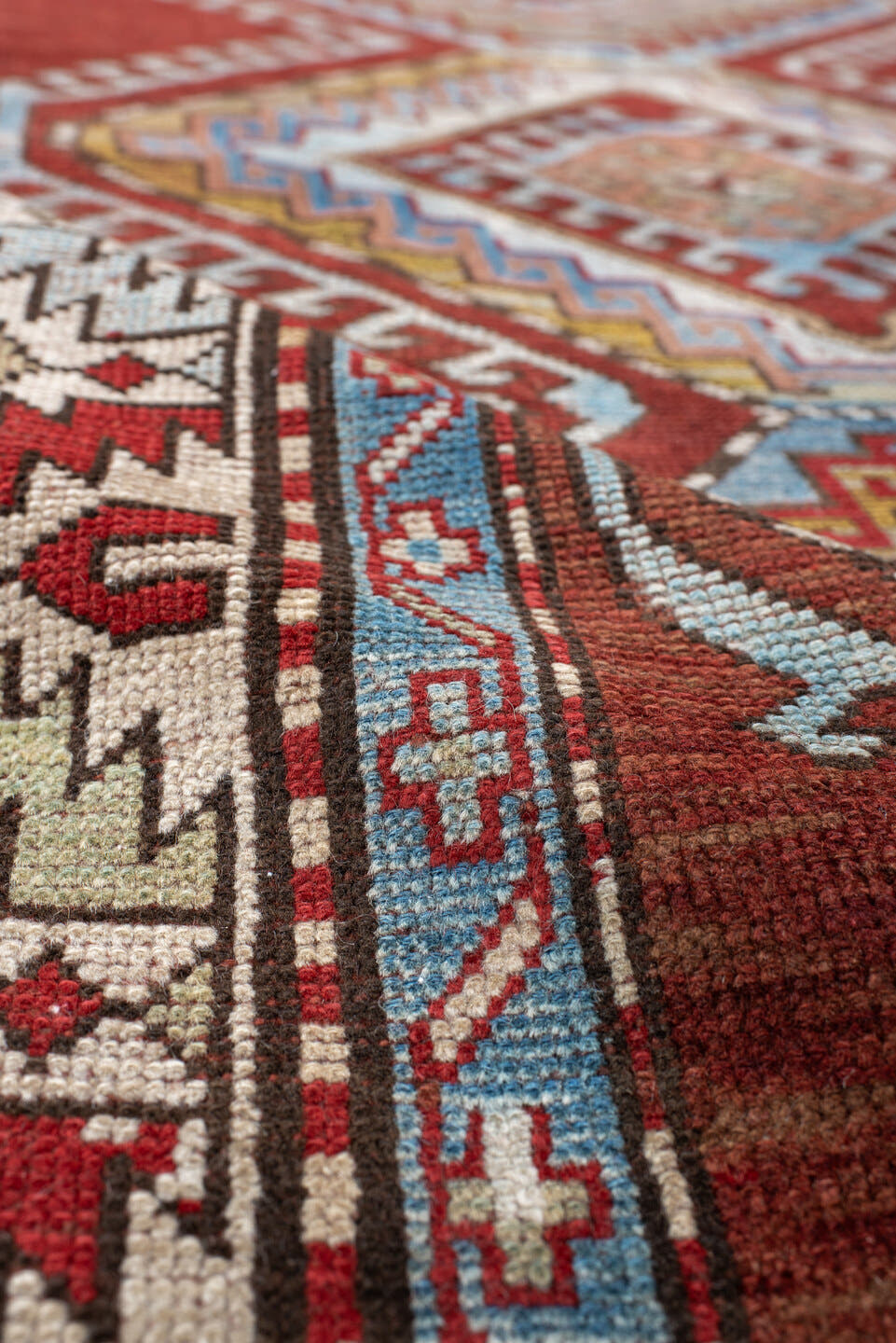 4' x 7' one-of-a-kind handmade vintage Kazak rug. Color palette: rust, ivory, sky blue, brick red, camel, taupe, gold, brown