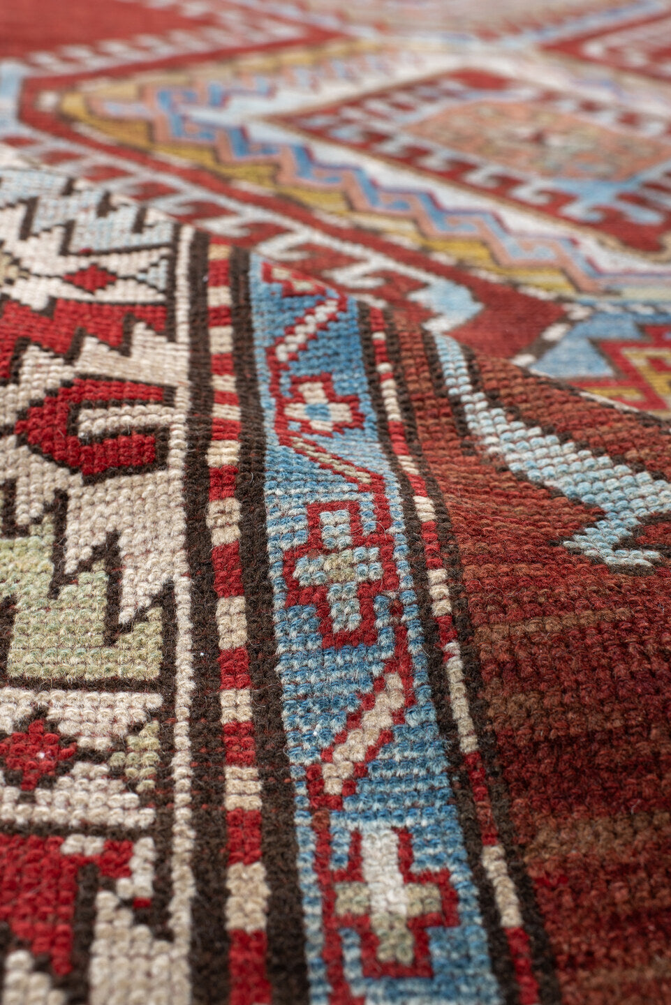 4' x 7' one-of-a-kind handmade vintage Kazak rug. Color palette: rust, ivory, sky blue, brick red, camel, taupe, gold, brown