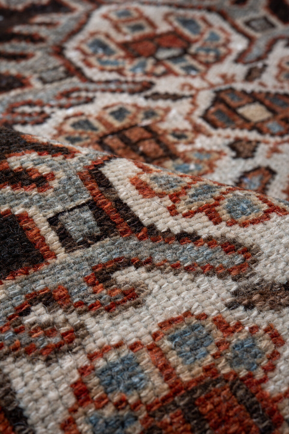 4' x 5' one-of-a-kind handmade vintage Baktiary small size rug. Color palette: black, brown, charcoal, gray, light gray