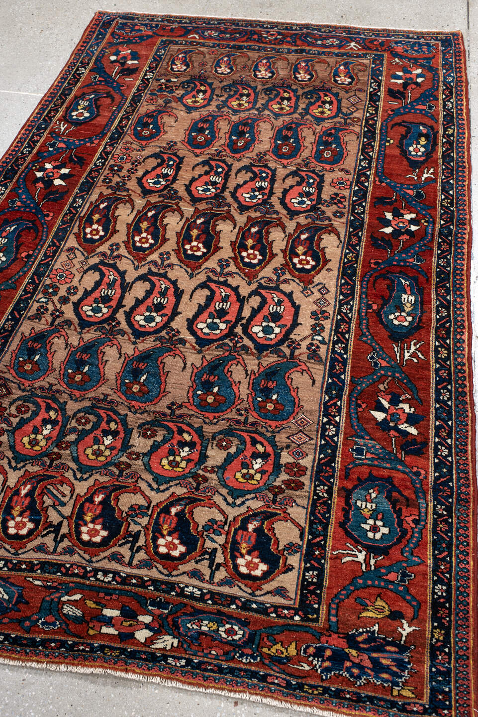 4' x 7' one-of-a-kind handmade antique Baktiary rug. Color palette: rust, indigo, ivory, brick, sky_blue, navy, cream, gold