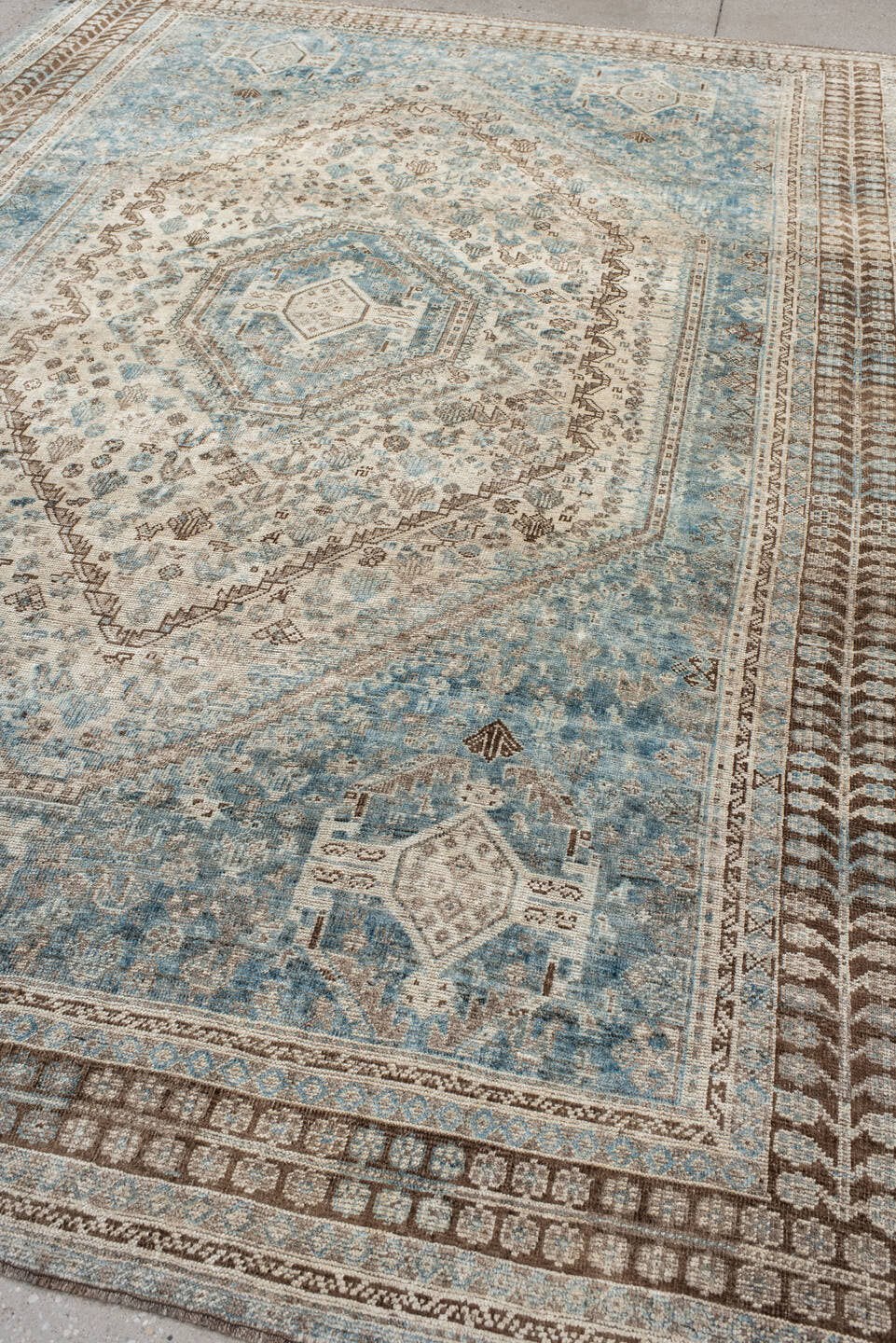 7' x 11' one-of-a-kind handmade antique Shiraz large size rug. Color palette: sky blue, ivory, brown, taupe, camel, slate