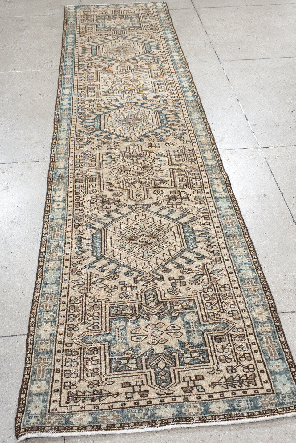 2' x 11' one-of-a-kind handmade antique Karaje runner rug. Color palette: ivory, sky blue, brown, taupe, camel, light blue