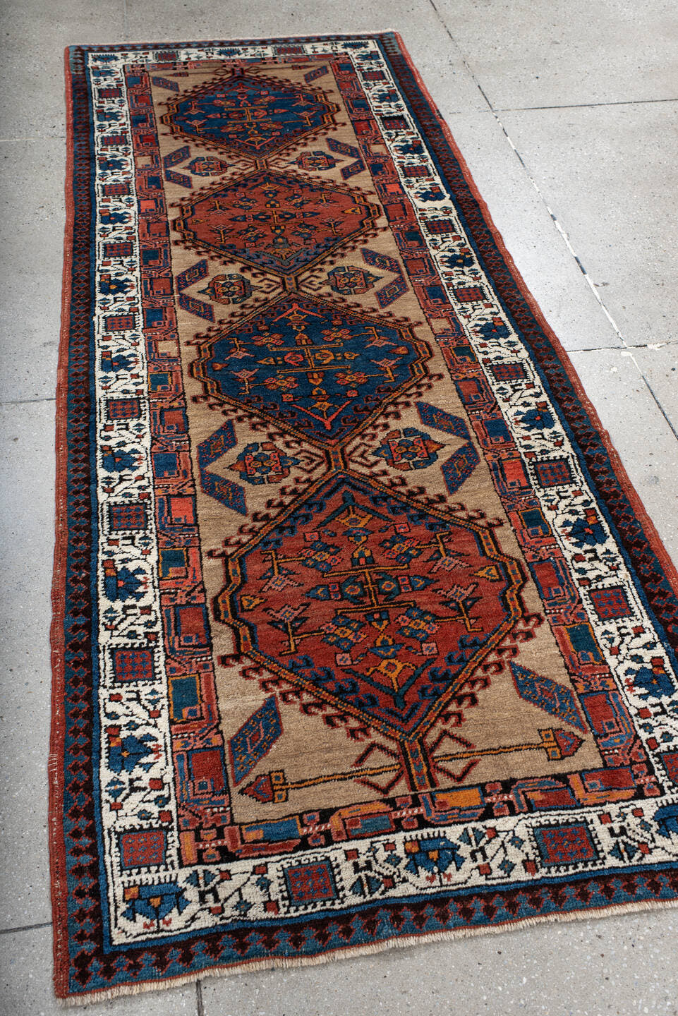 3' x 8' one-of-a-kind handmade antique Sarab runner rug. Color palette: ivory, indigo, rust, navy, terra cotta, camel