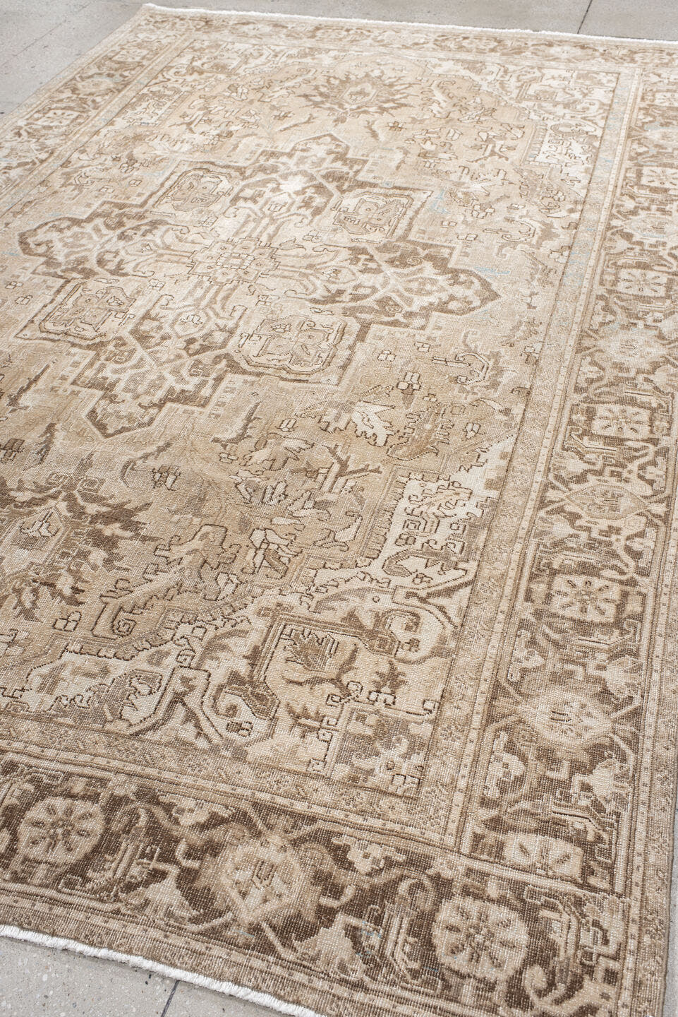 7' x 10' one-of-a-kind handmade antique Heriz large size rug. Color palette: ivory, taupe, beige, brown, camel, pale blue