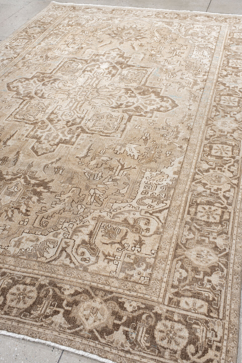 7' x 10' one-of-a-kind handmade antique Heriz large size rug. Color palette: ivory, taupe, beige, brown, camel, pale blue