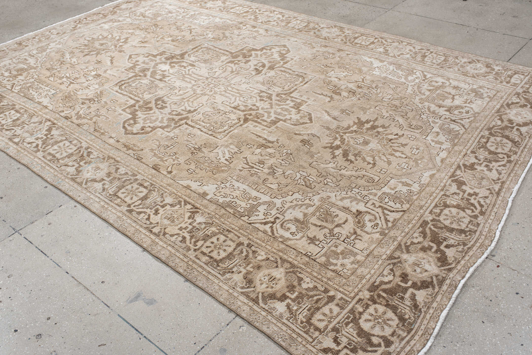 7' x 10' one-of-a-kind handmade antique Heriz large size rug. Color palette: ivory, taupe, beige, brown, camel, pale blue