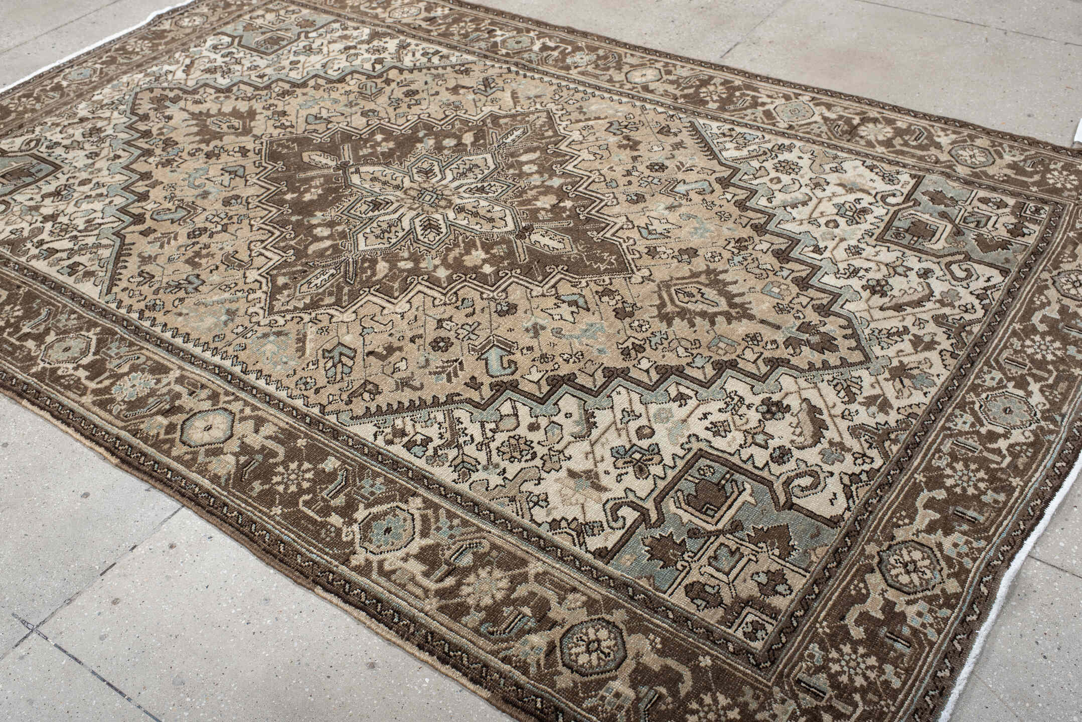 6' x 9' one-of-a-kind handmade antique Heriz medium size rug. Color palette: brown, ivory, sky blue, taupe, camel, slate
