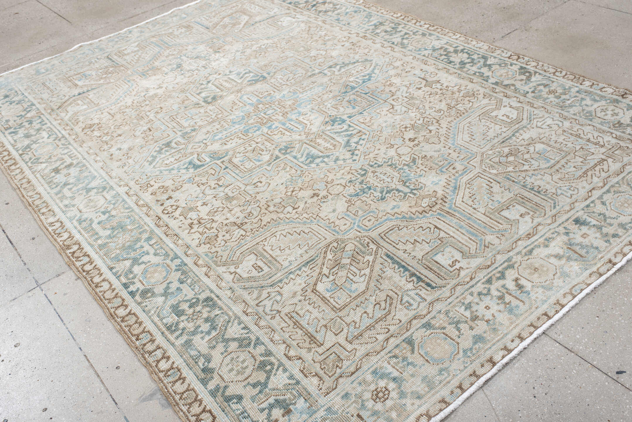 6' x 9' one-of-a-kind handmade antique Heriz medium size rug. Color palette: ivory, sky blue, taupe, beige, slate, camel