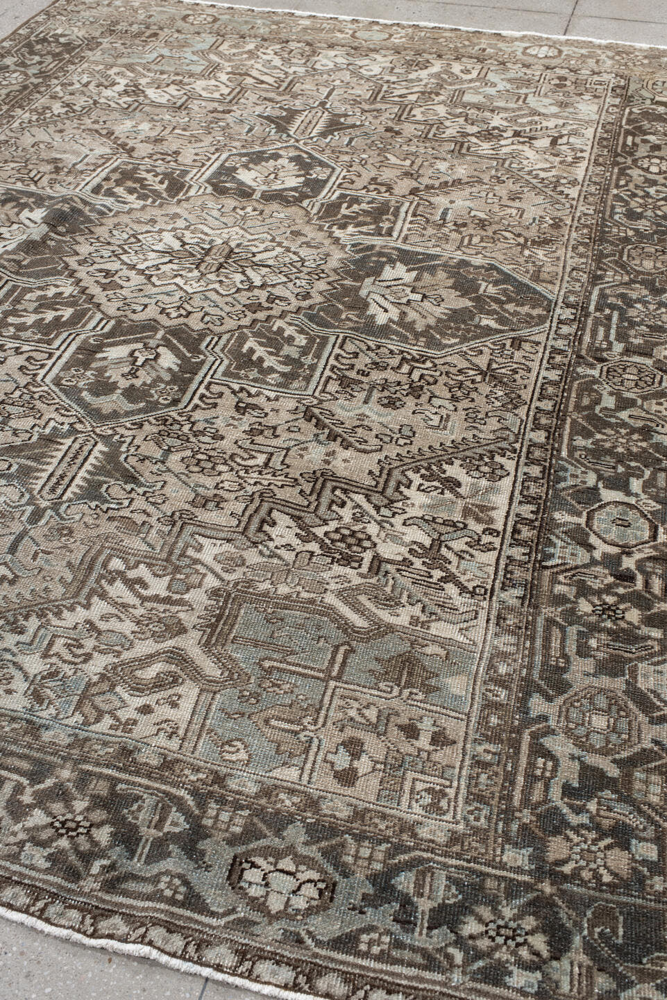 7' x 9' one-of-a-kind handmade antique Heriz large size rug. Color palette: taupe, charcoal, ivory, camel, slate, brown