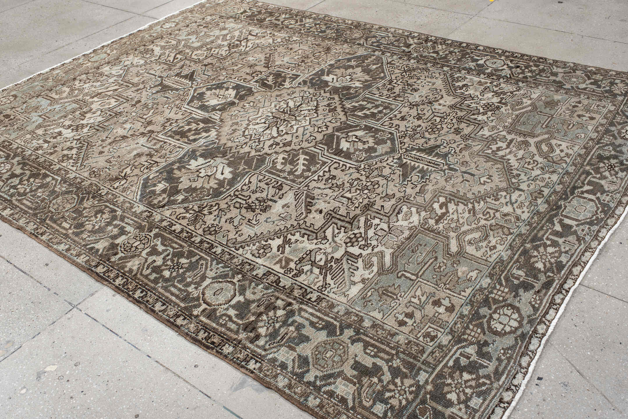7' x 9' one-of-a-kind handmade antique Heriz large size rug. Color palette: taupe, charcoal, ivory, camel, slate, brown