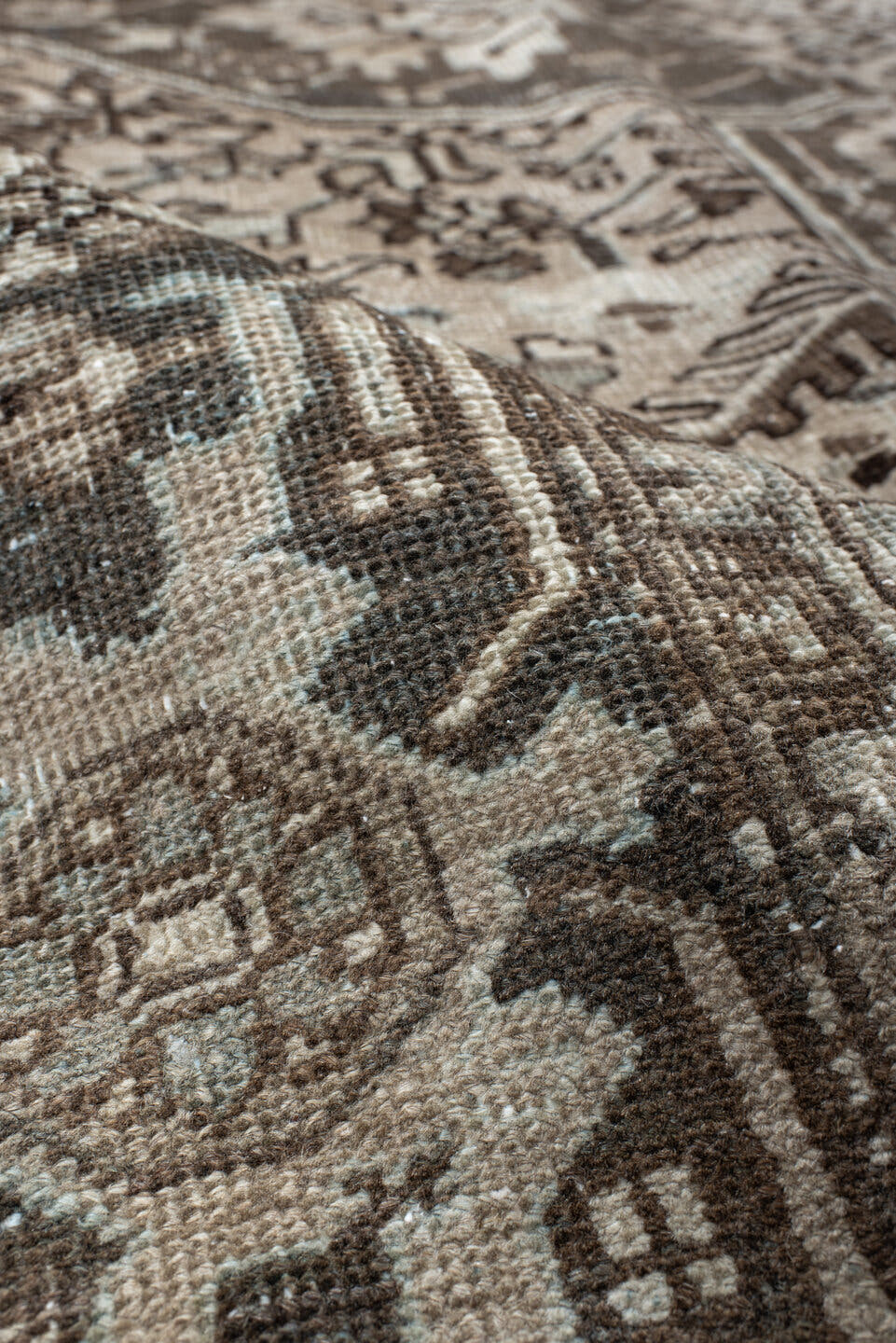 7' x 9' one-of-a-kind handmade antique Heriz large size rug. Color palette: taupe, charcoal, ivory, camel, slate, brown