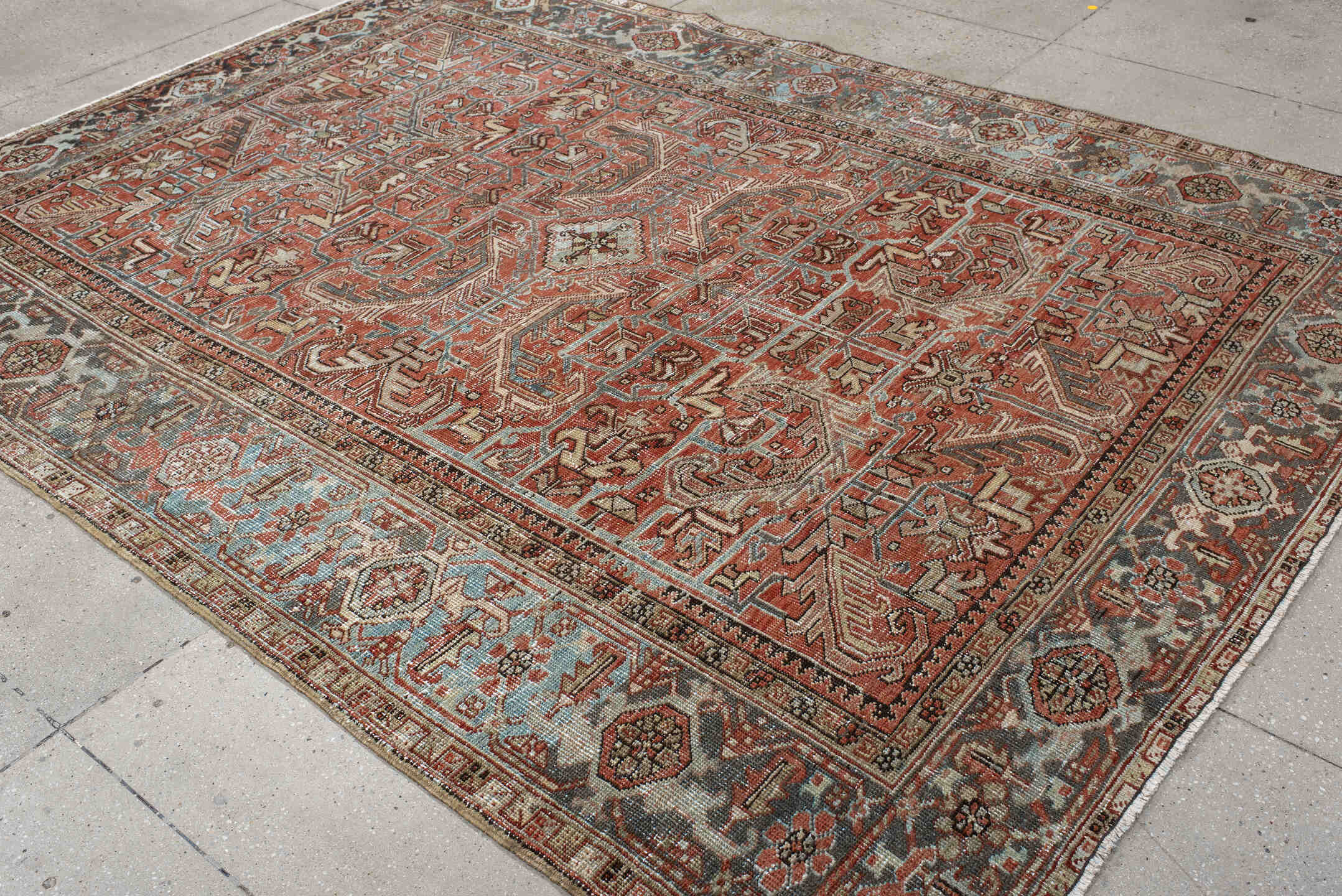 7' x 9' one-of-a-kind handmade antique Heriz large size rug. Color palette: terra cotta, ivory, slate, charcoal, rust, camel