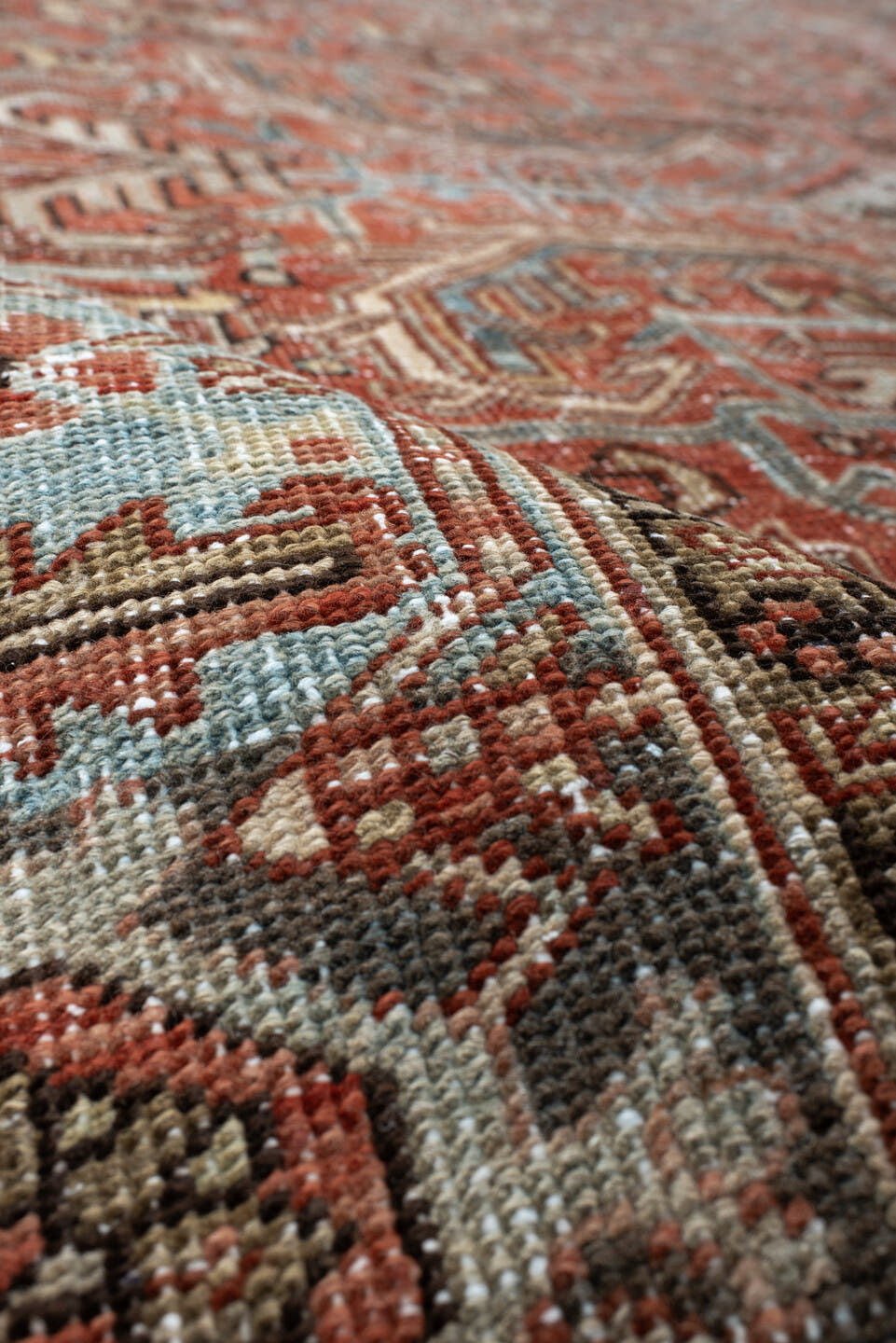 7' x 9' one-of-a-kind handmade antique Heriz large size rug. Color palette: terra cotta, ivory, slate, charcoal, rust, camel