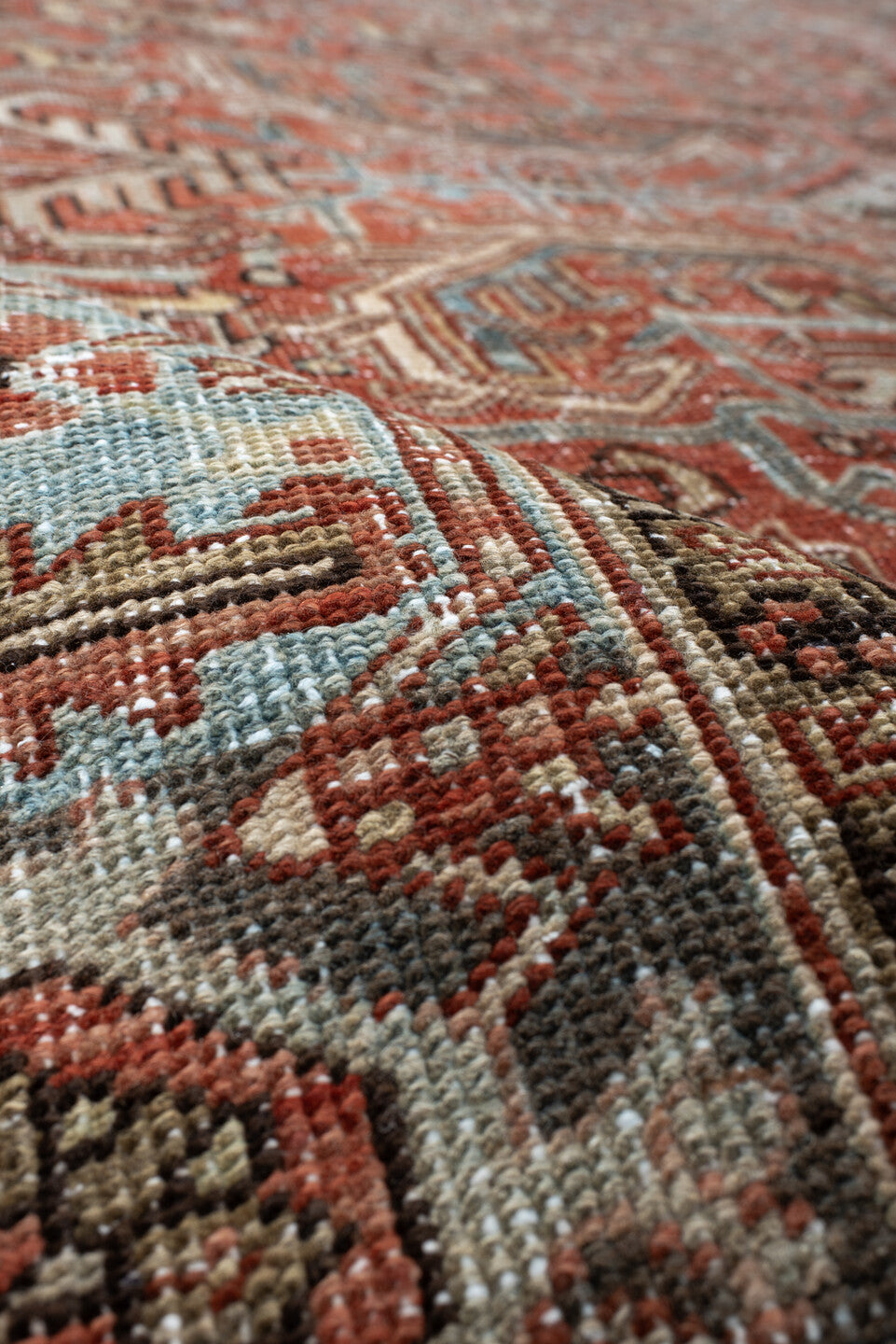 7' x 9' one-of-a-kind handmade antique Heriz large size rug. Color palette: terra cotta, ivory, slate, charcoal, rust, camel