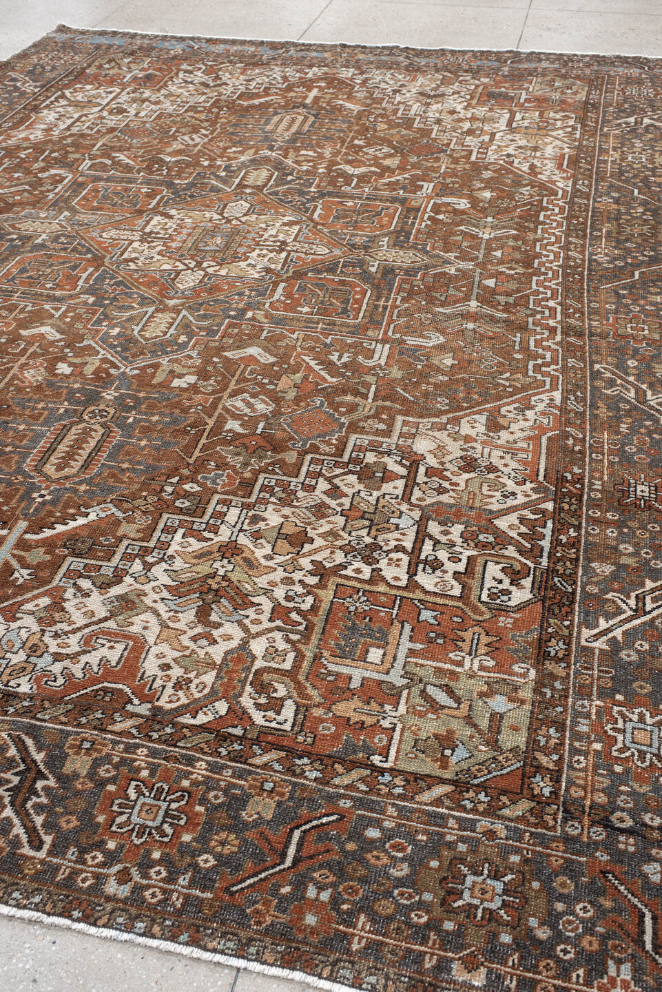 9' x 12' one-of-a-kind handmade antique Karaje large size rug. Color palette: rust, ivory, indigo, brown, terra cotta, slate