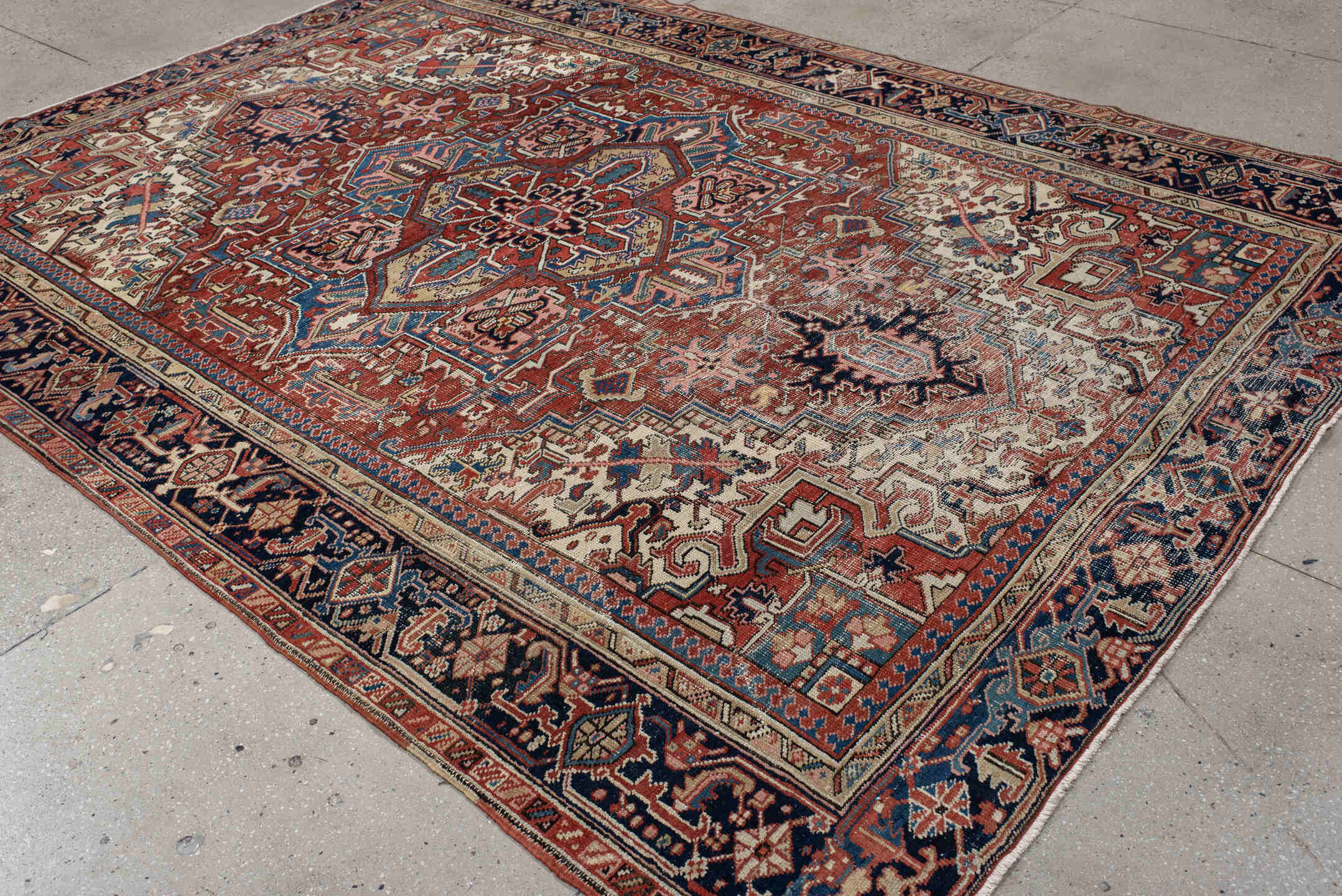 7' x 10' one-of-a-kind handmade antique Heriz large size rug. Color palette: rust, ivory, navy, sky_blue, brick, coral