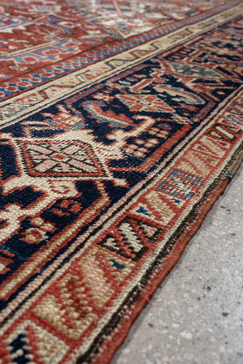 7' x 10' one-of-a-kind handmade antique Heriz large size rug. Color palette: rust, ivory, navy, sky_blue, brick, coral