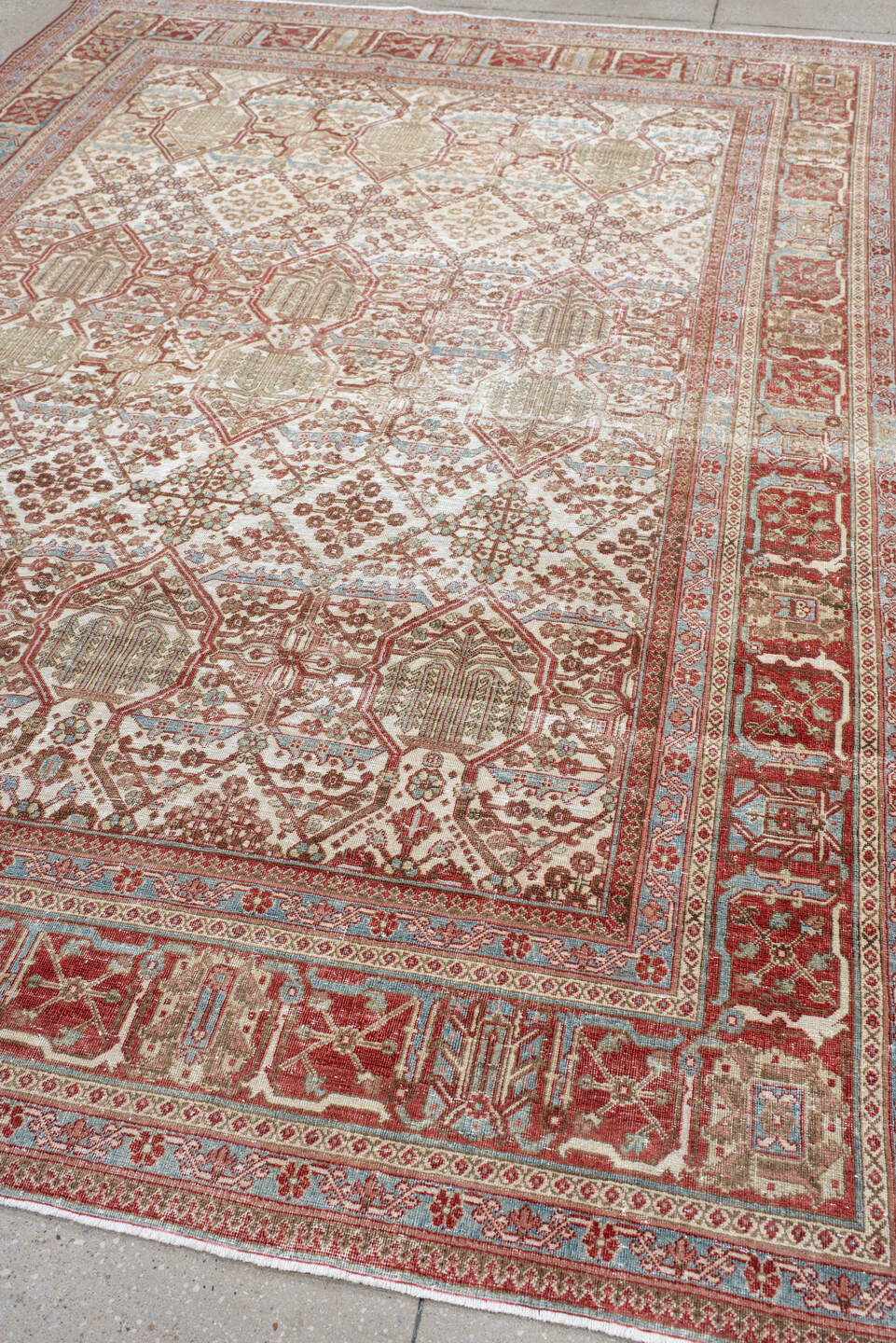 7' x 10' one-of-a-kind handmade antique Joshegan large size rug. Color palette: ivory, rust, sky_blue, camel, brick, taupe