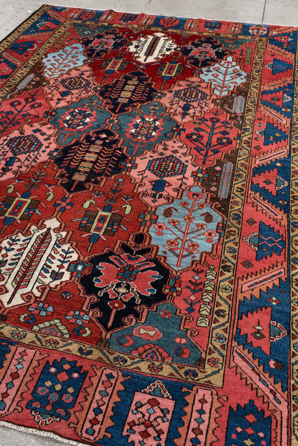 6' x 10' one-of-a-kind handmade antique Baktiary large size rug. Color palette: rust, indigo, rose, ivory, sky blue, navy