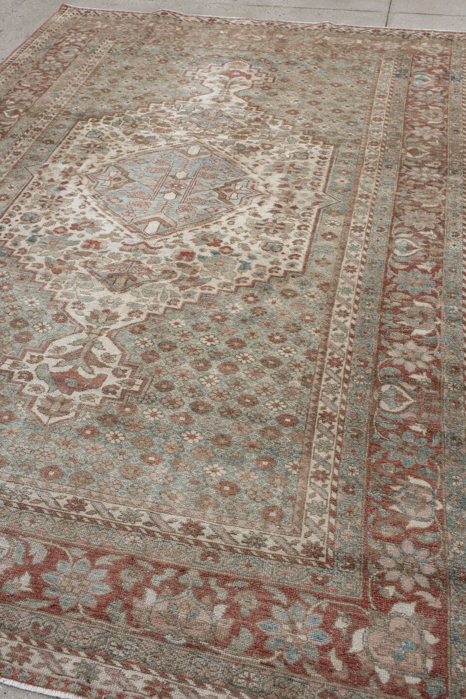 6' x 10' one-of-a-kind handmade antique Baktiary large size rug. Color palette: ivory, dusty blue, rose, taupe, terra cotta