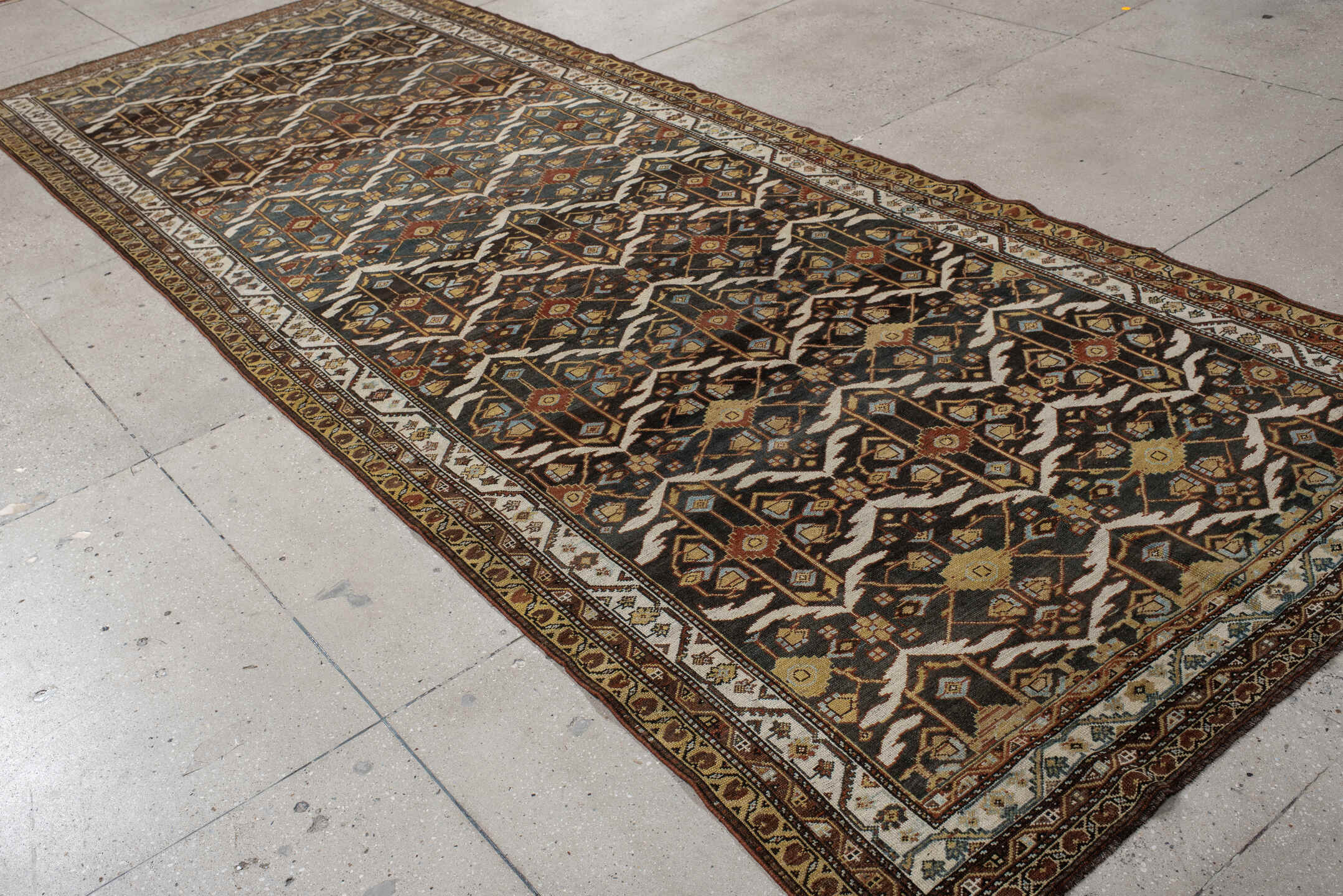 5' x 14' one-of-a-kind handmade antique Baktiary rug. Color palette: brown, ivory, camel, slate, rust, gold, charcoal