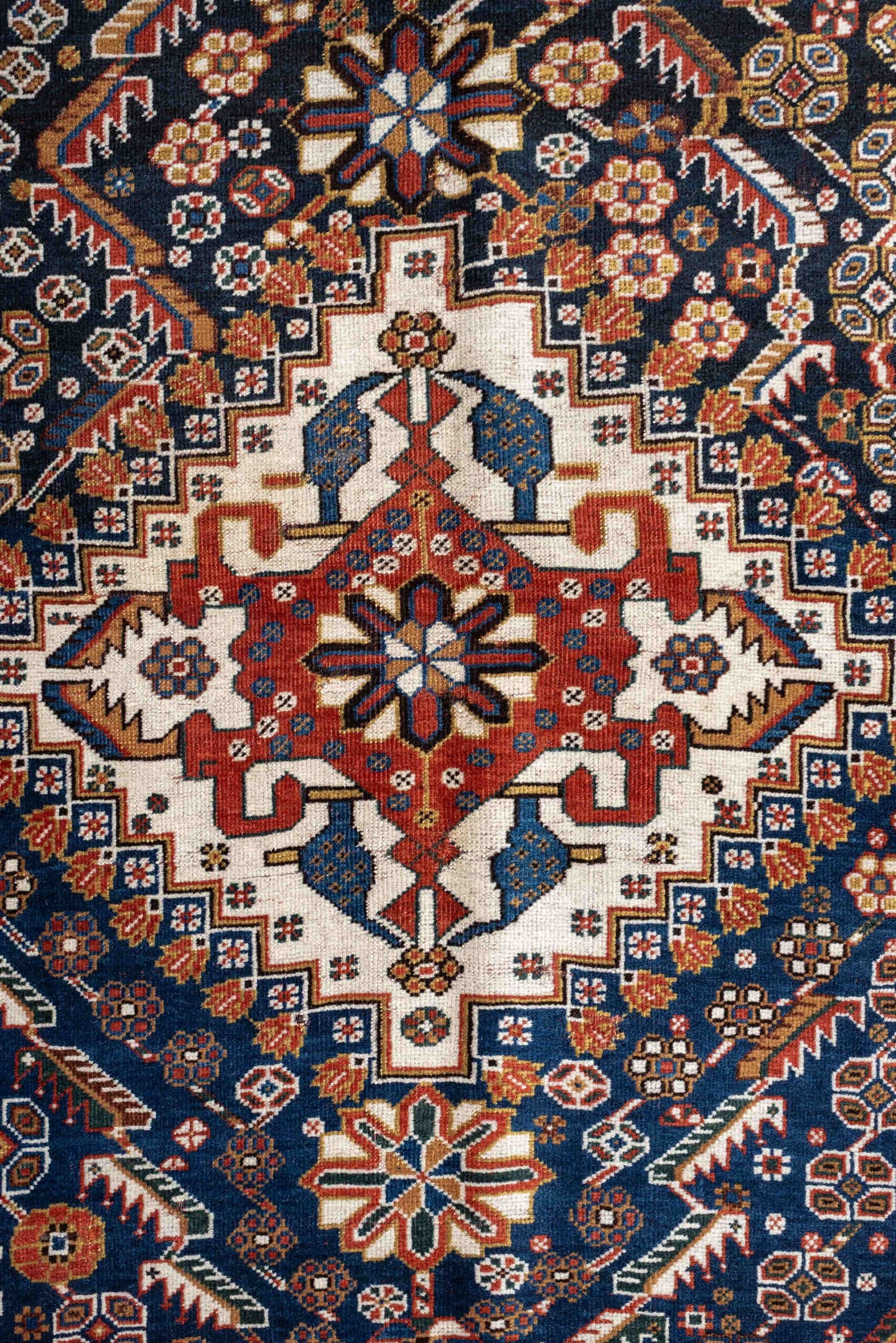 4' x 8' one-of-a-kind handmade vintage Shirvan medium size rug. Color palette: rust, navy, ivory, camel, saffron, indigo