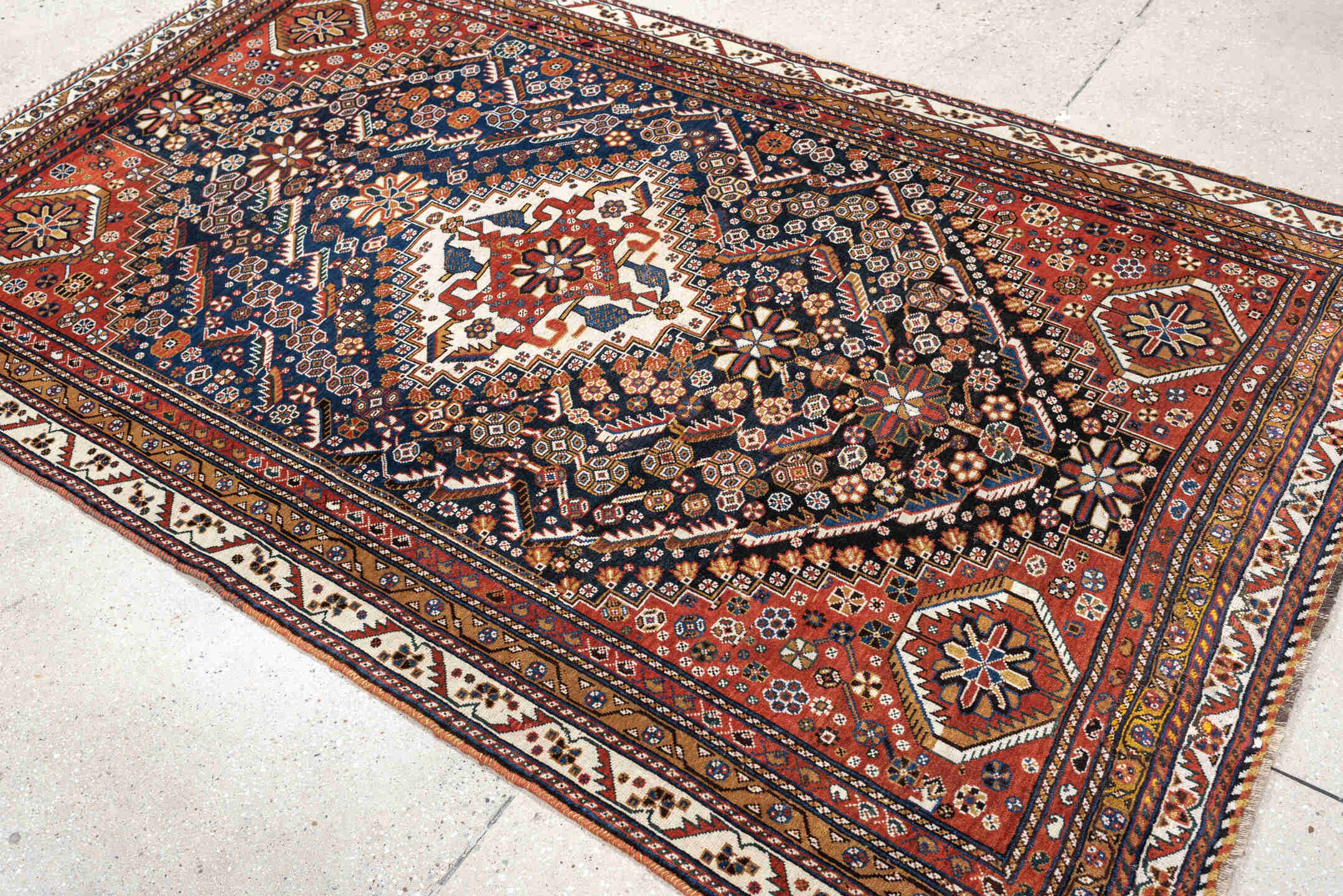 4' x 8' one-of-a-kind handmade vintage Shirvan medium size rug. Color palette: rust, navy, ivory, camel, saffron, indigo