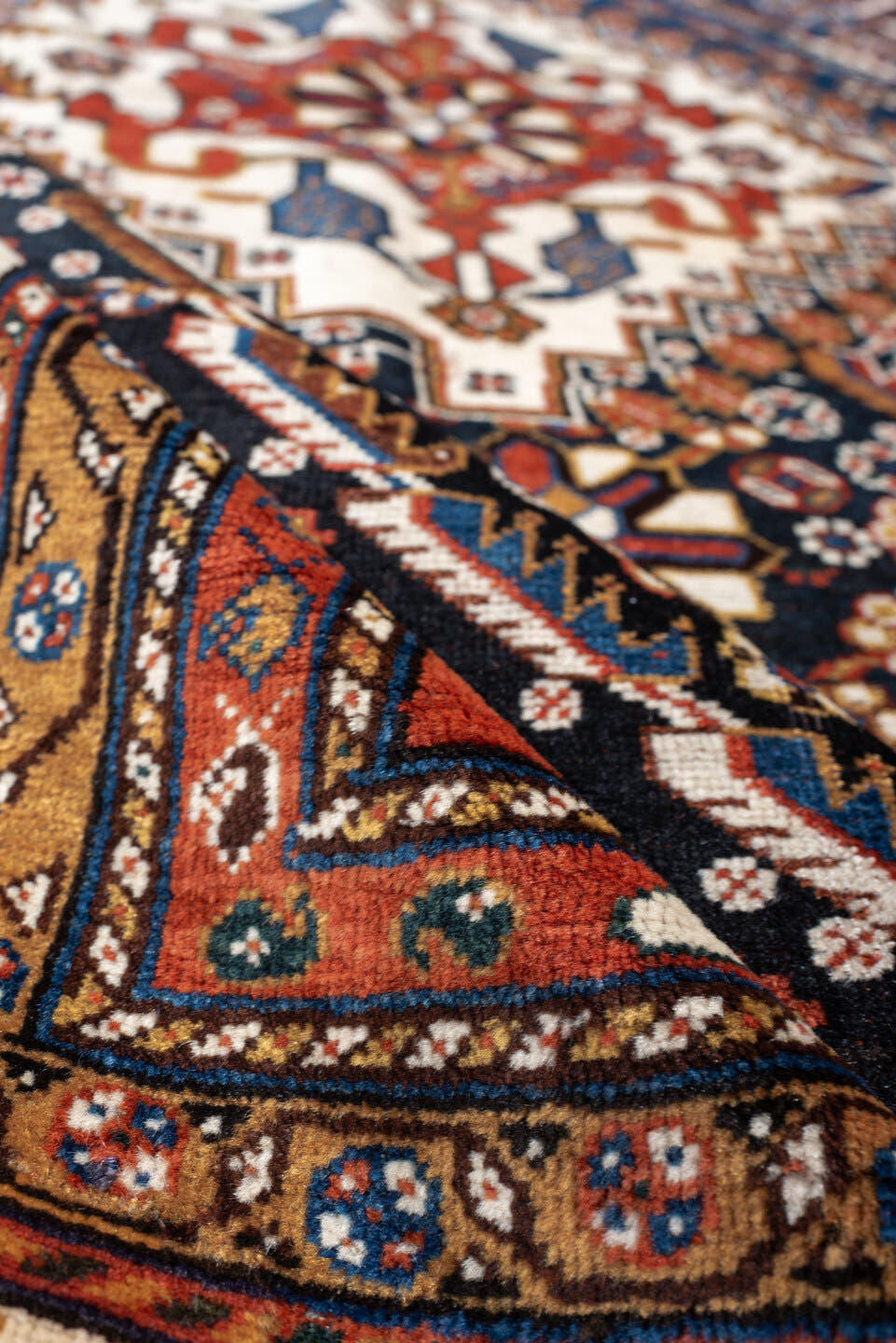 4' x 8' one-of-a-kind handmade vintage Shirvan medium size rug. Color palette: rust, navy, ivory, camel, saffron, indigo