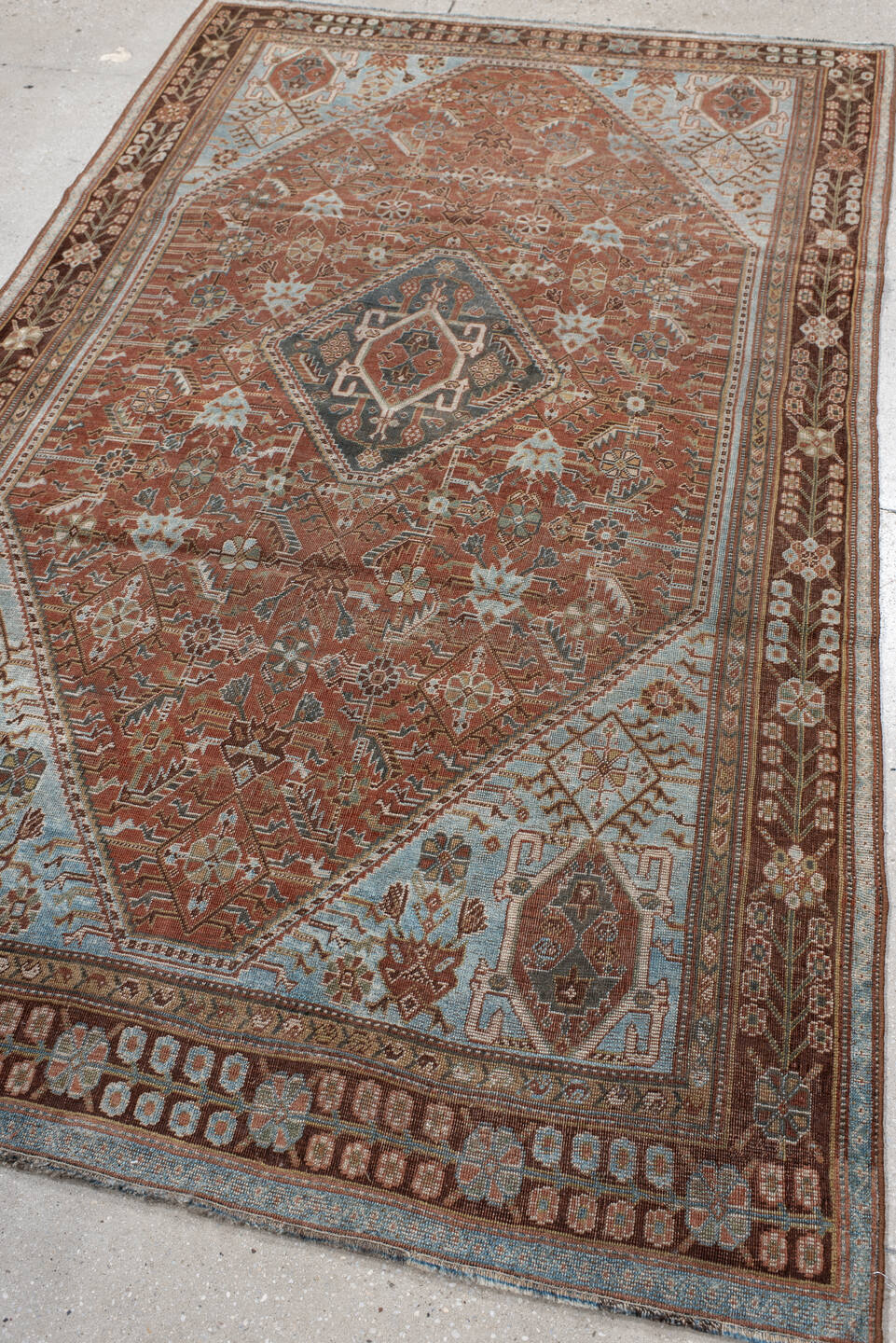 4' x 7' one-of-a-kind handmade vintage Qashqai rug. Color palette: terra cotta, pale blue, ivory, dark brown, slate, taupe