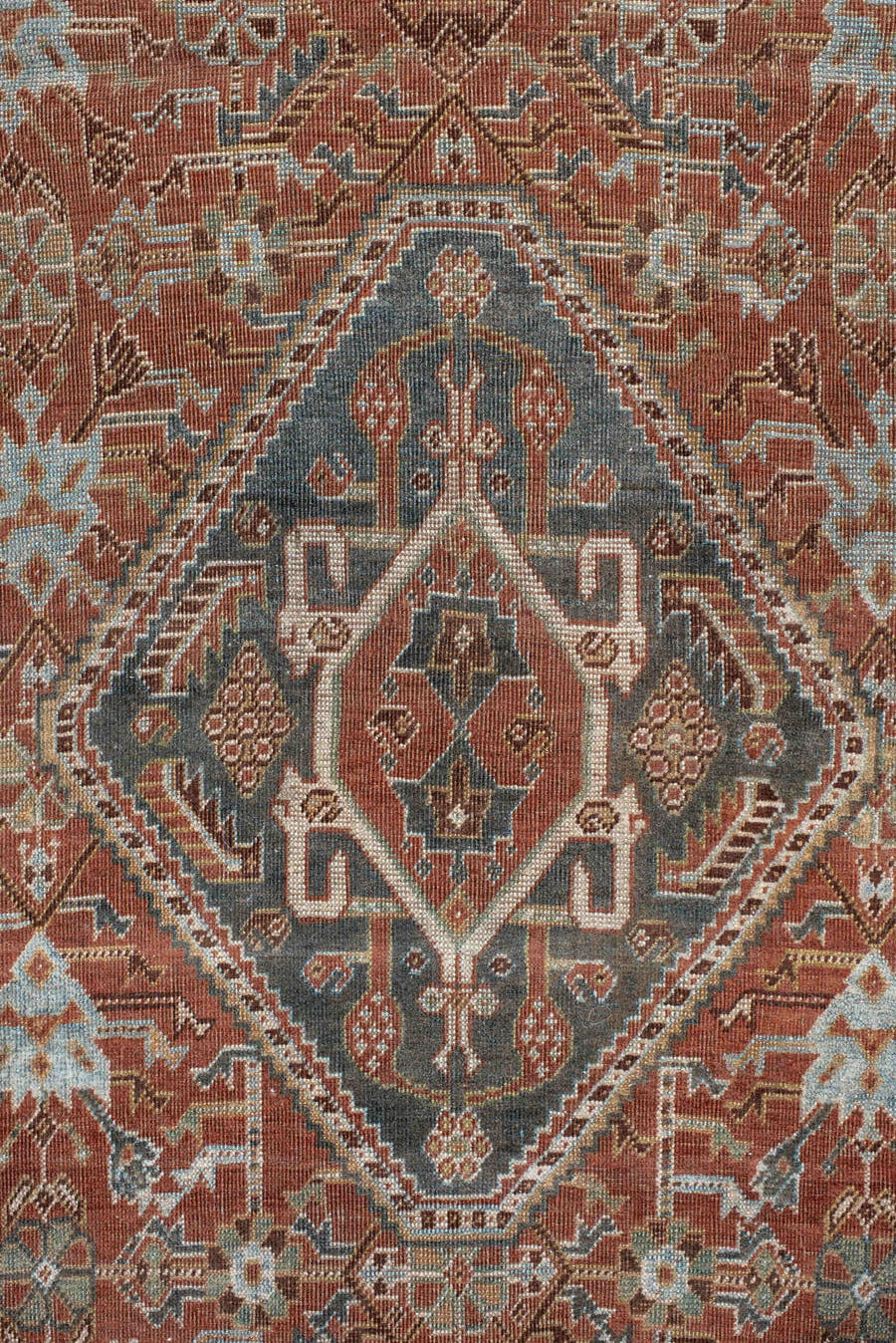 4' x 7' one-of-a-kind handmade vintage Qashqai rug. Color palette: terra cotta, pale blue, ivory, dark brown, slate, taupe