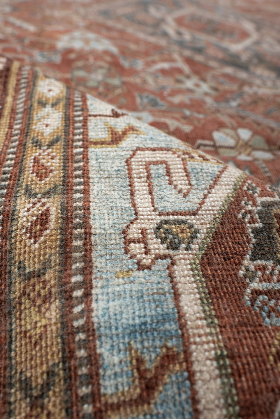 4' x 7' one-of-a-kind handmade vintage Qashqai rug. Color palette: terra cotta, pale blue, ivory, dark brown, slate, taupe