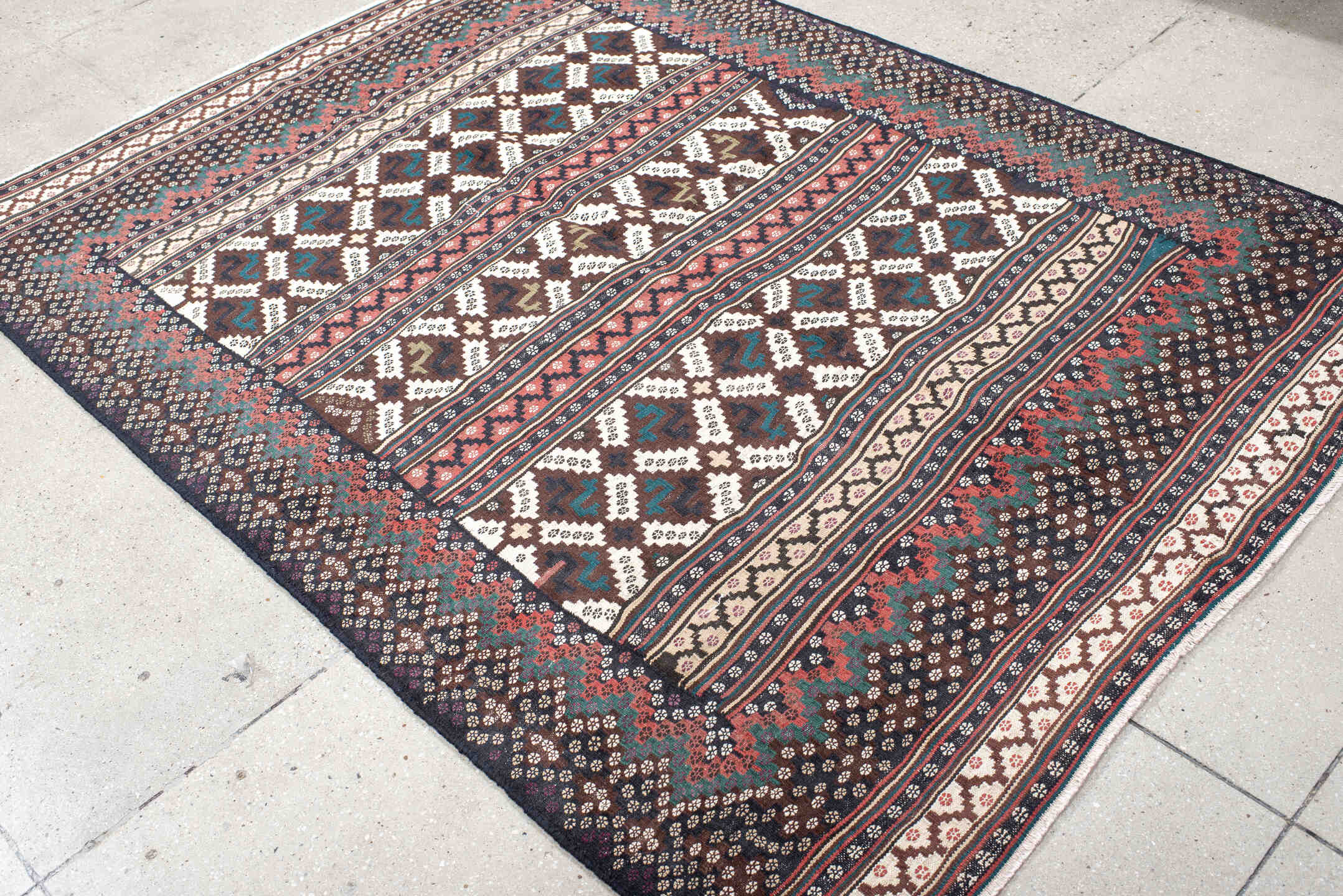 5' x 7' one-of-a-kind handmade vintage Kilim rug. Color palette: brown, ivory, rose, teal, charcoal, olive, pink, red, gray
